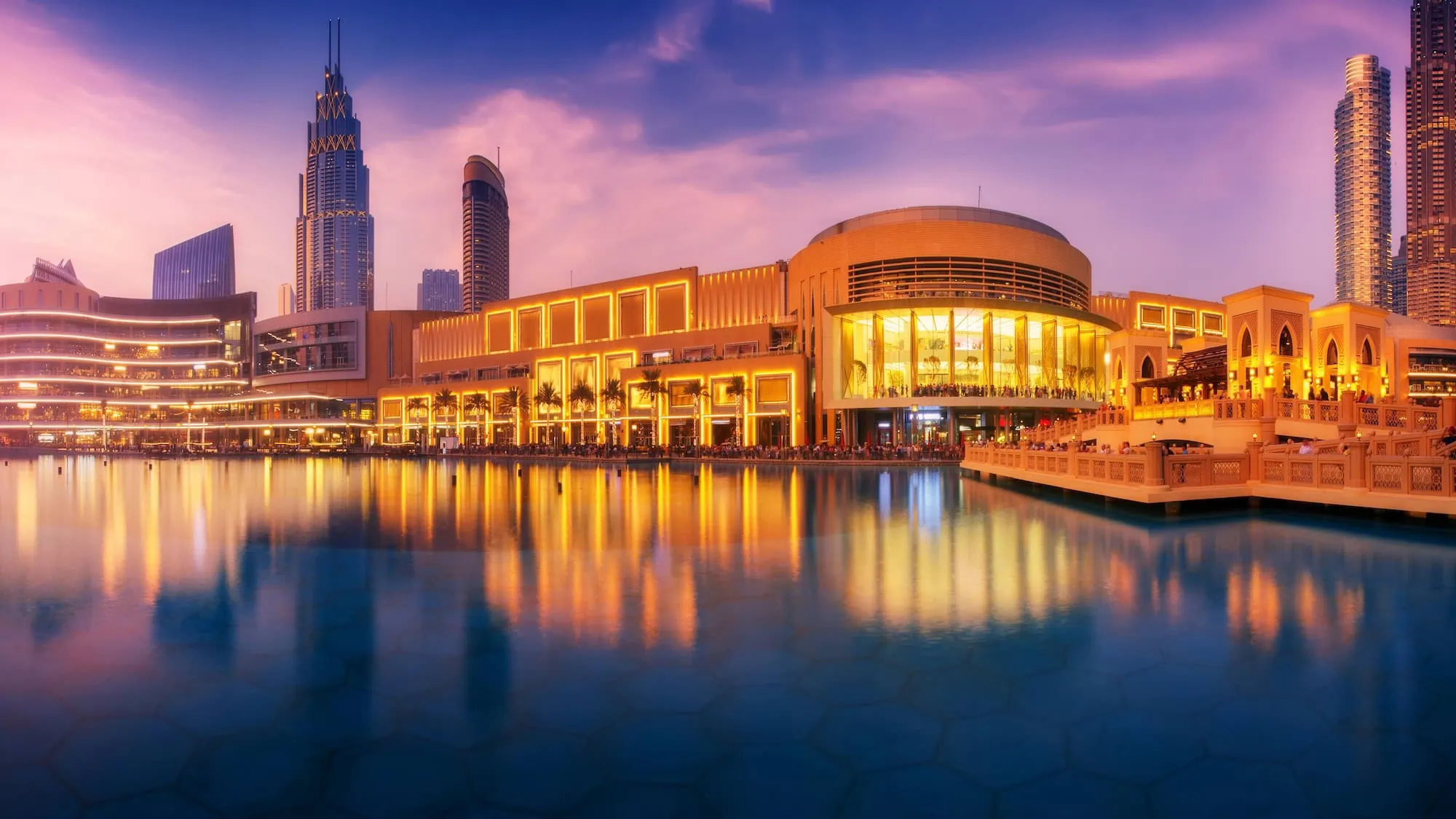 Evening view of Dubai Mall and Downtown Dubai skyline reflected in water
