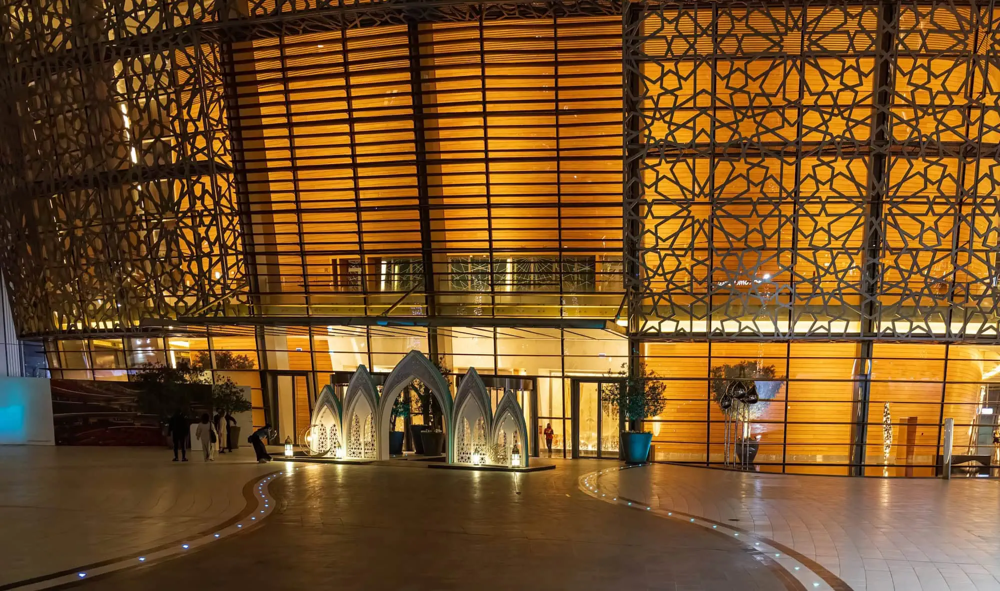 Interior of Dubai Opera house showing geometric ceiling patterns and golden lighting