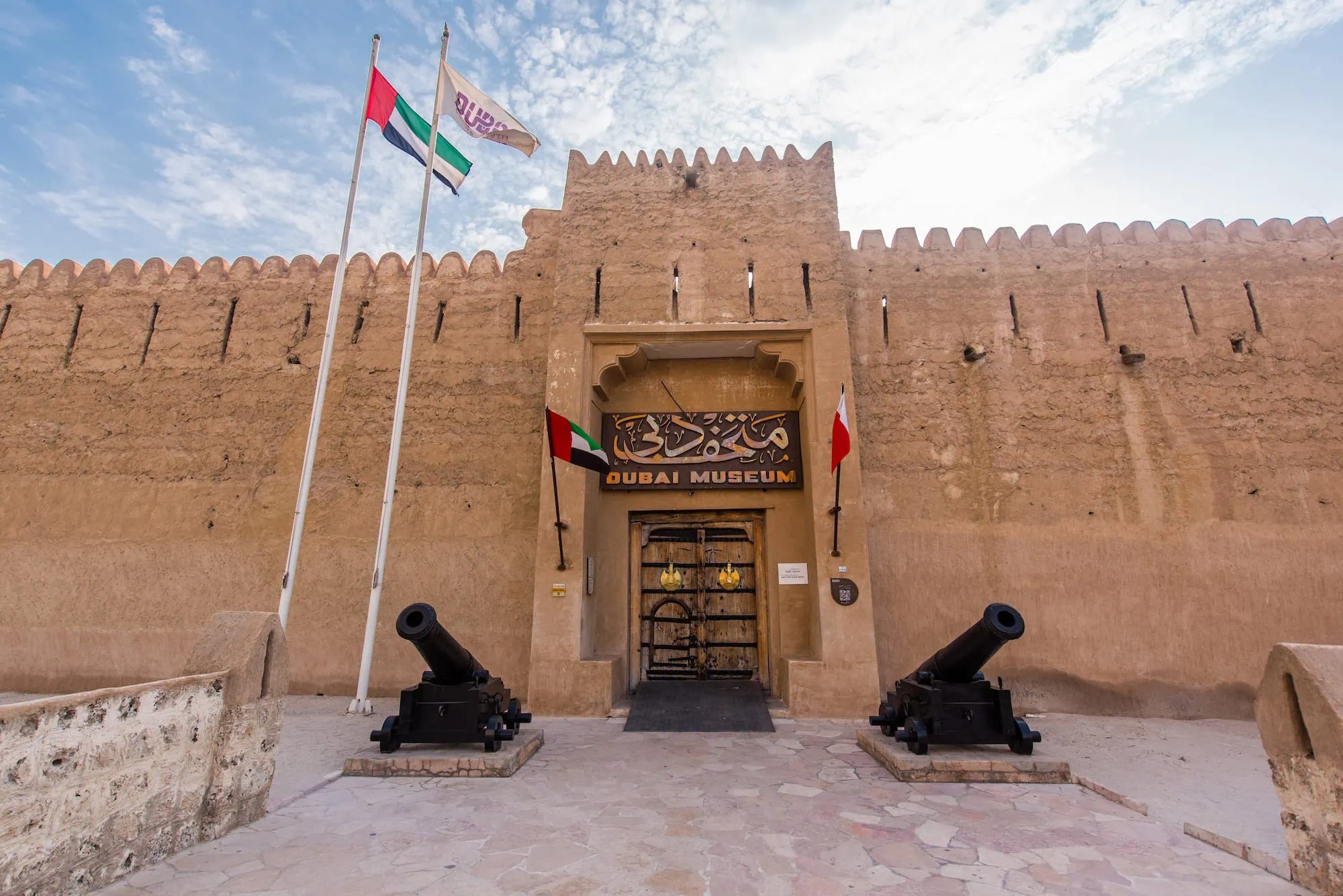 Dubai Museum housed in historic Al Fahidi Fort with traditional Arabic architecture and cannons