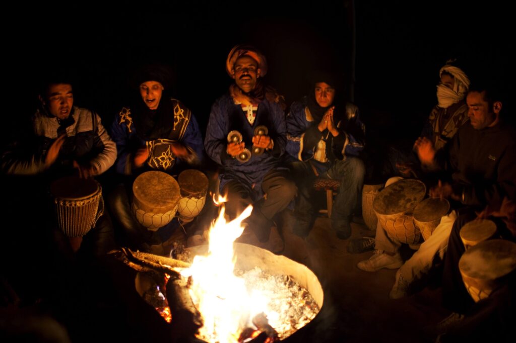 Bedouins playing traditional music at a Sahara Desert campsite