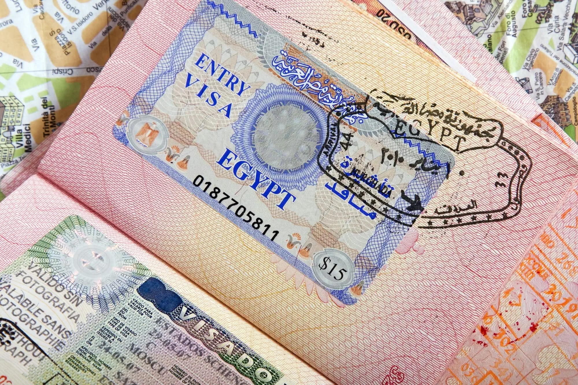 Egypt entry visa stamp in passport with travel documents and currency notes