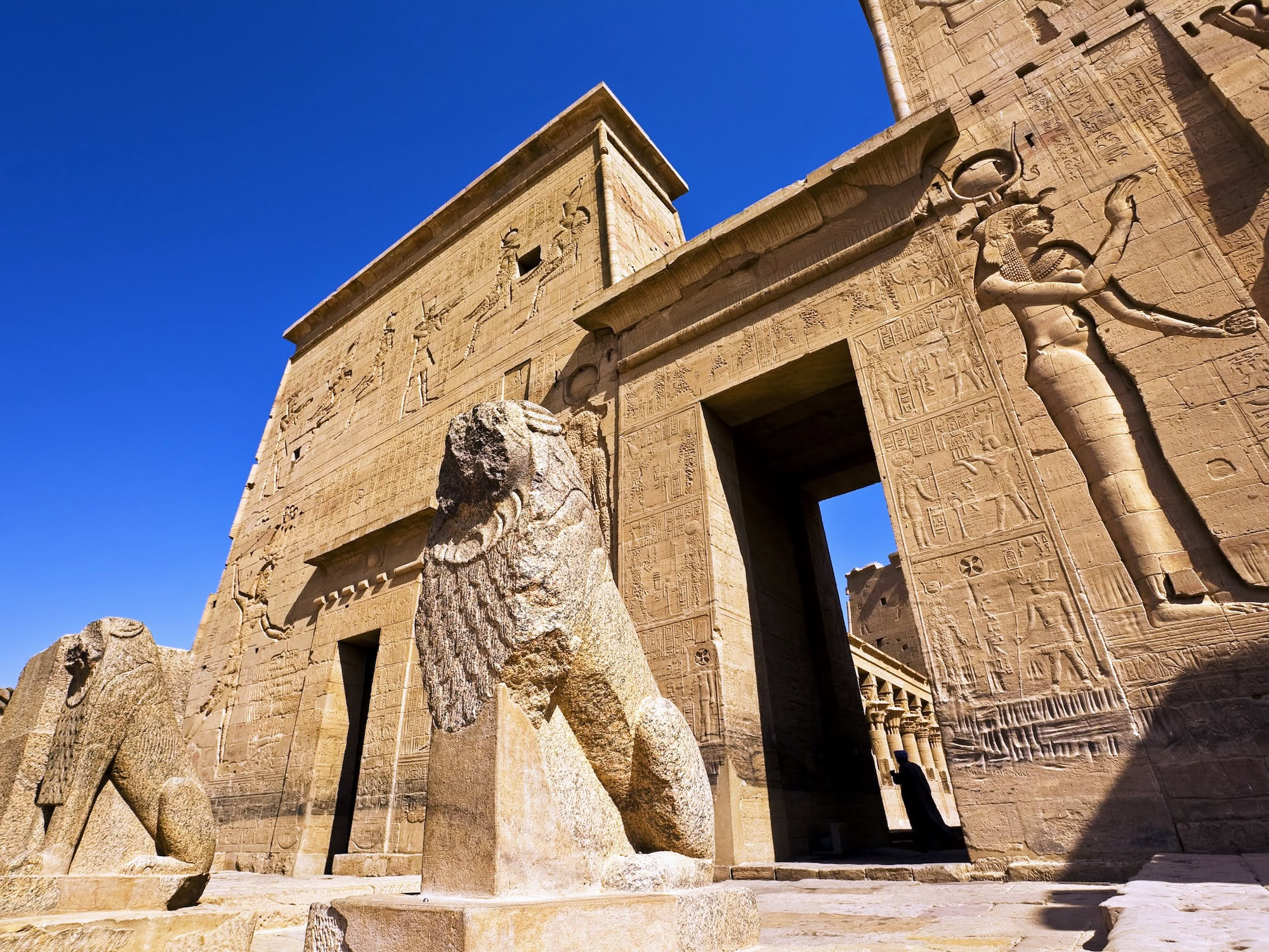Ancient Philae Temple with carved hieroglyphics, stone columns and pylon entrance in Egypt