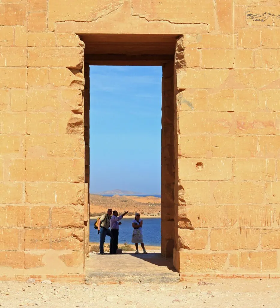 Temple of Dakka with tourists and a guide in the main doorway, Aswan
