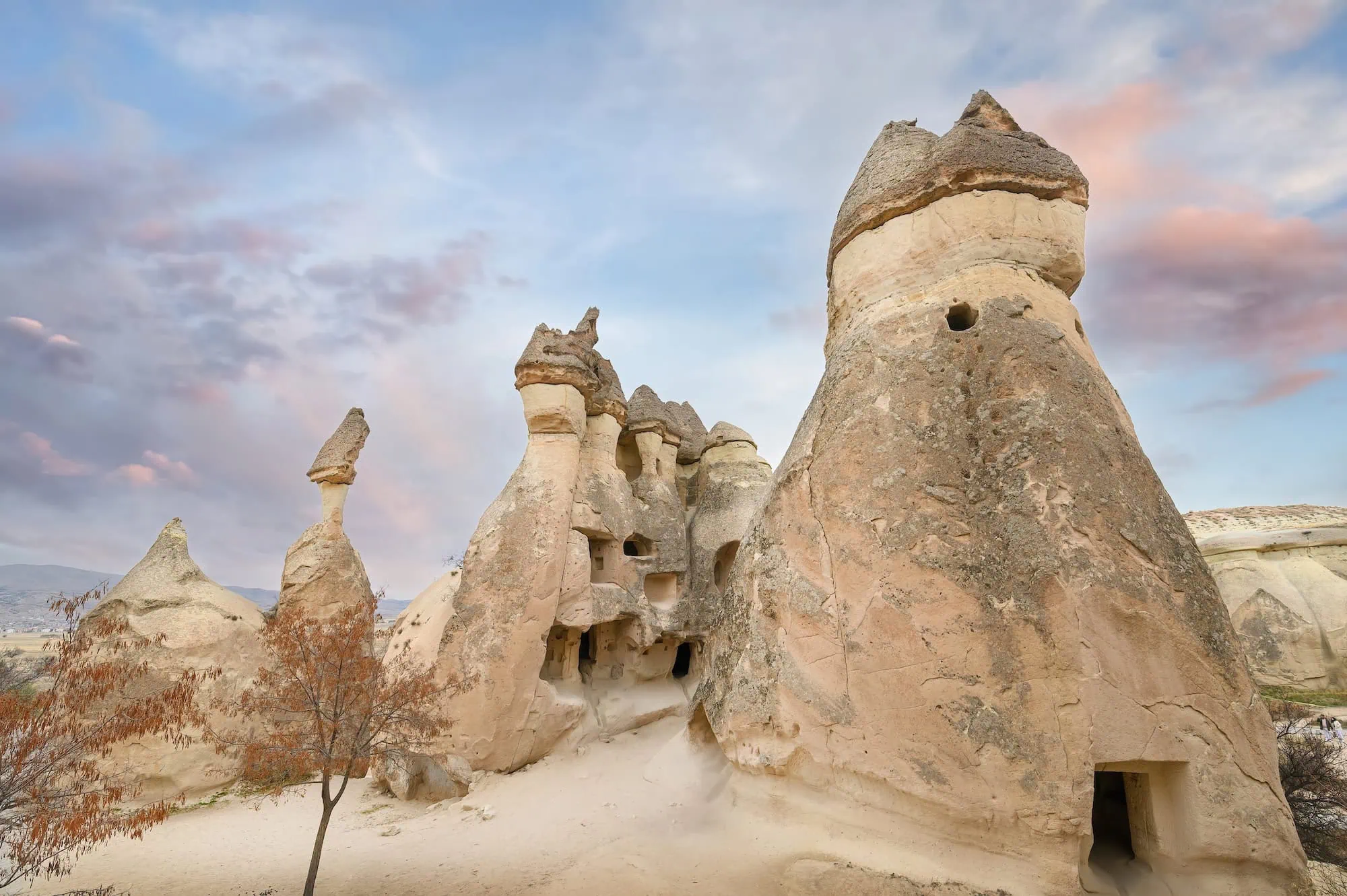 Fairy chimney rock formations in Cappadocia with cone-shaped structures and cave dwellings