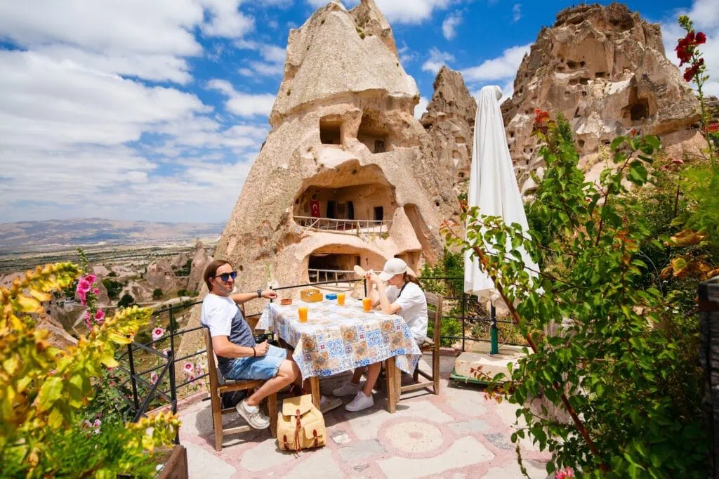 Uchisar Castle with surrounding fairy chimneys and rock formations viewed from a small café in Cappadocia, Nevsehir