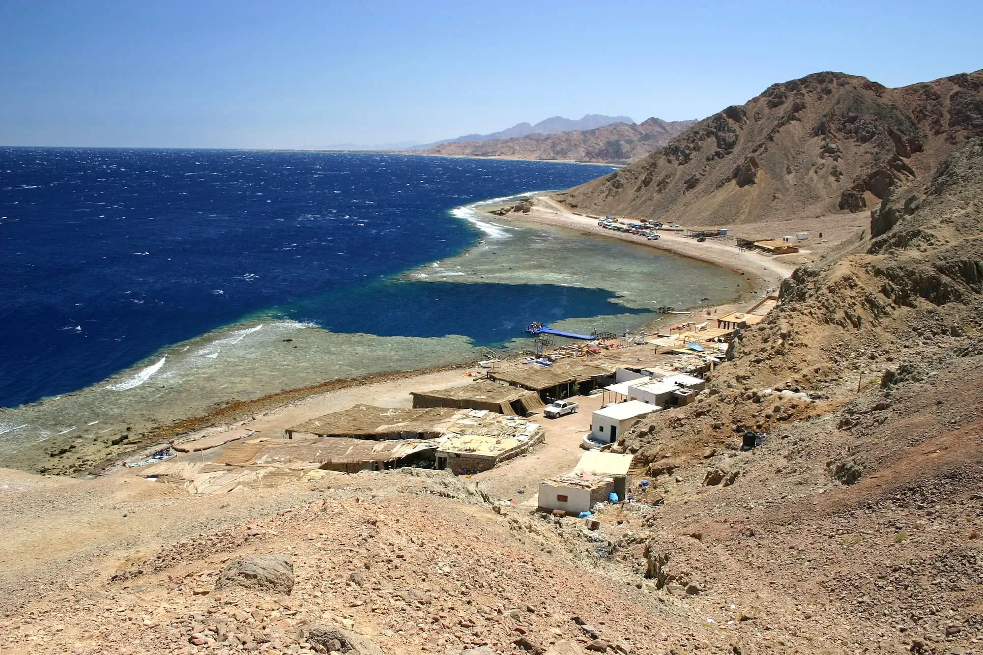 Blue Hole diving site at Red Sea coast with coral reef and pier