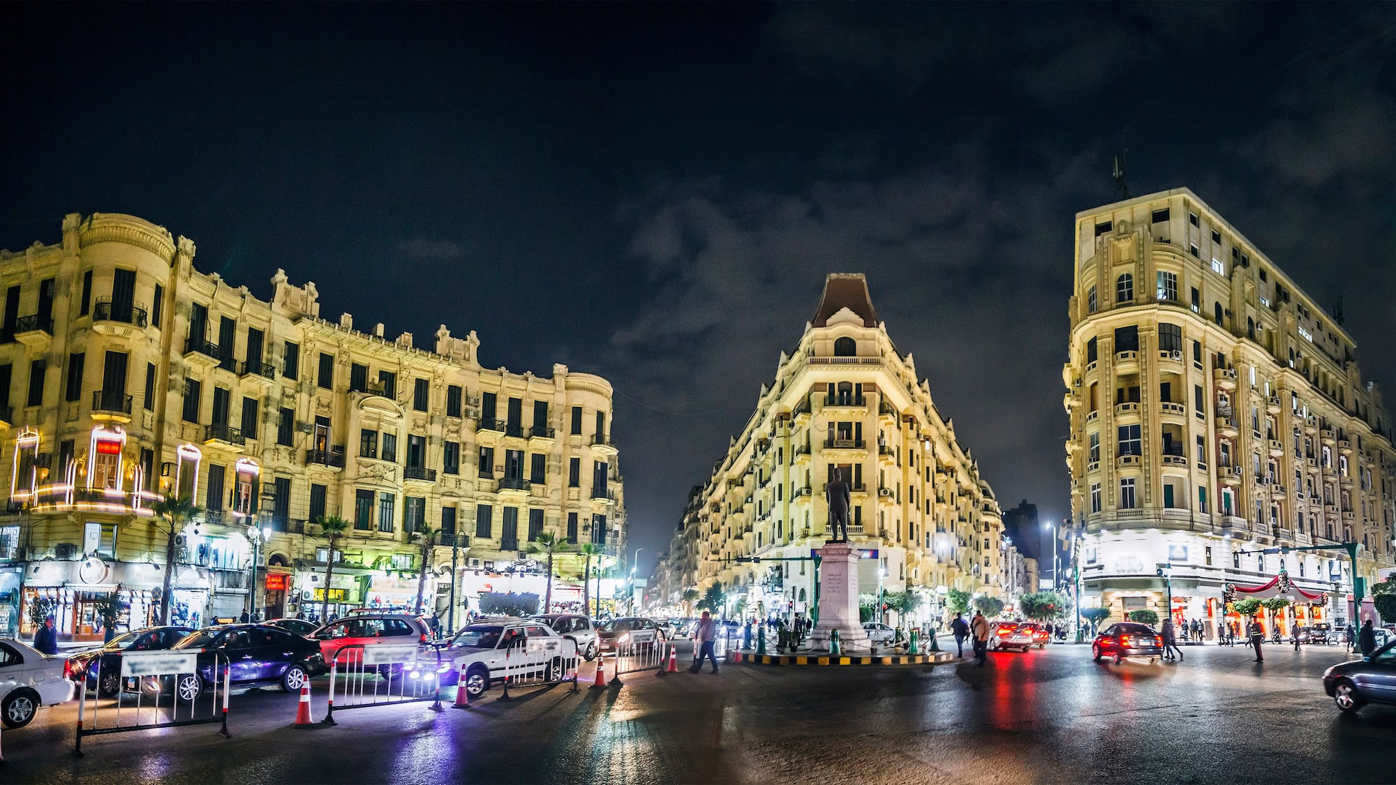 Plaza Talaat Harb en El Cairo por la noche con edificios coloniales y tráfico