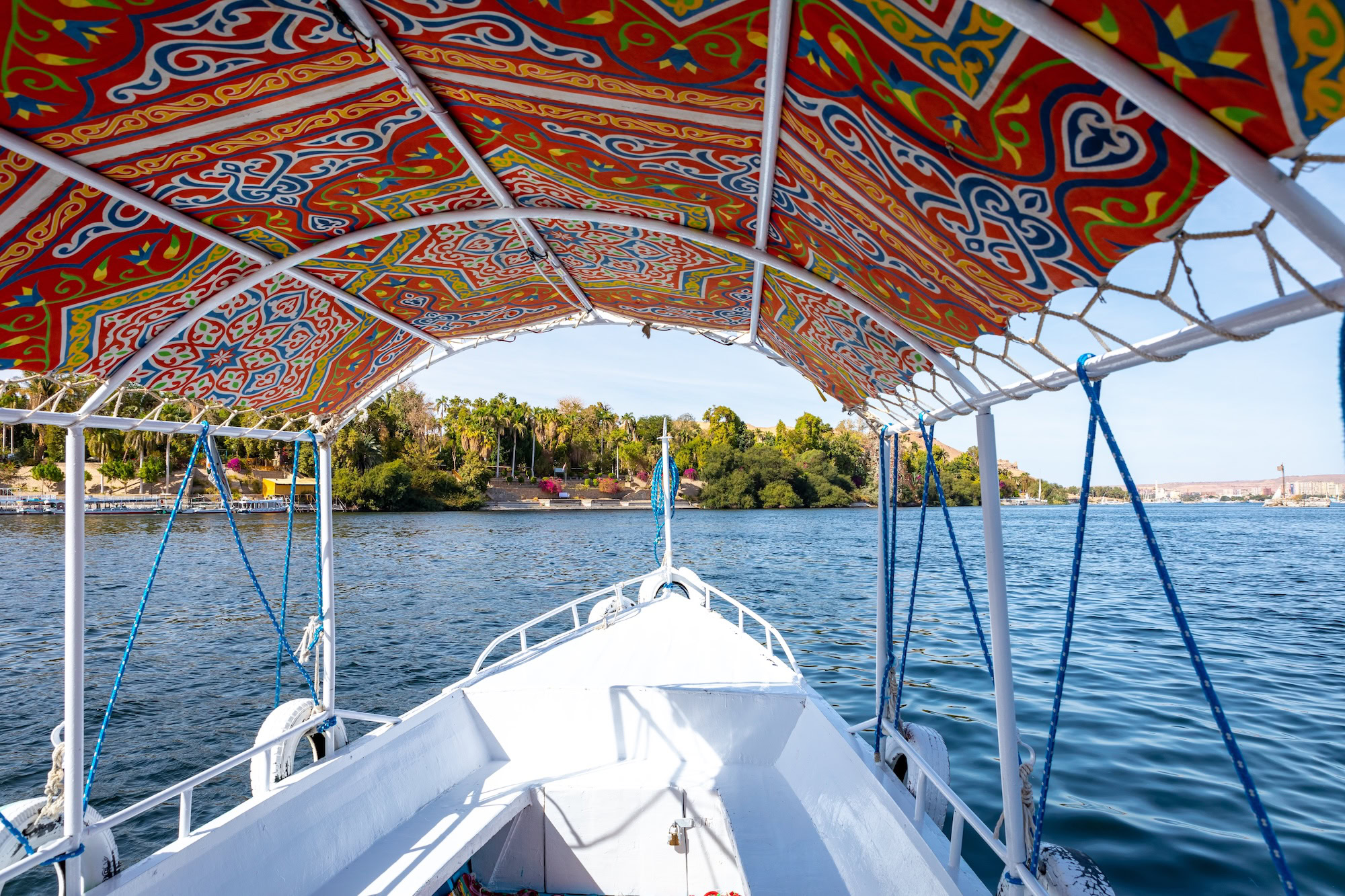 Traditional Dahabiya boat with decorated canopy sailing on the Nile River