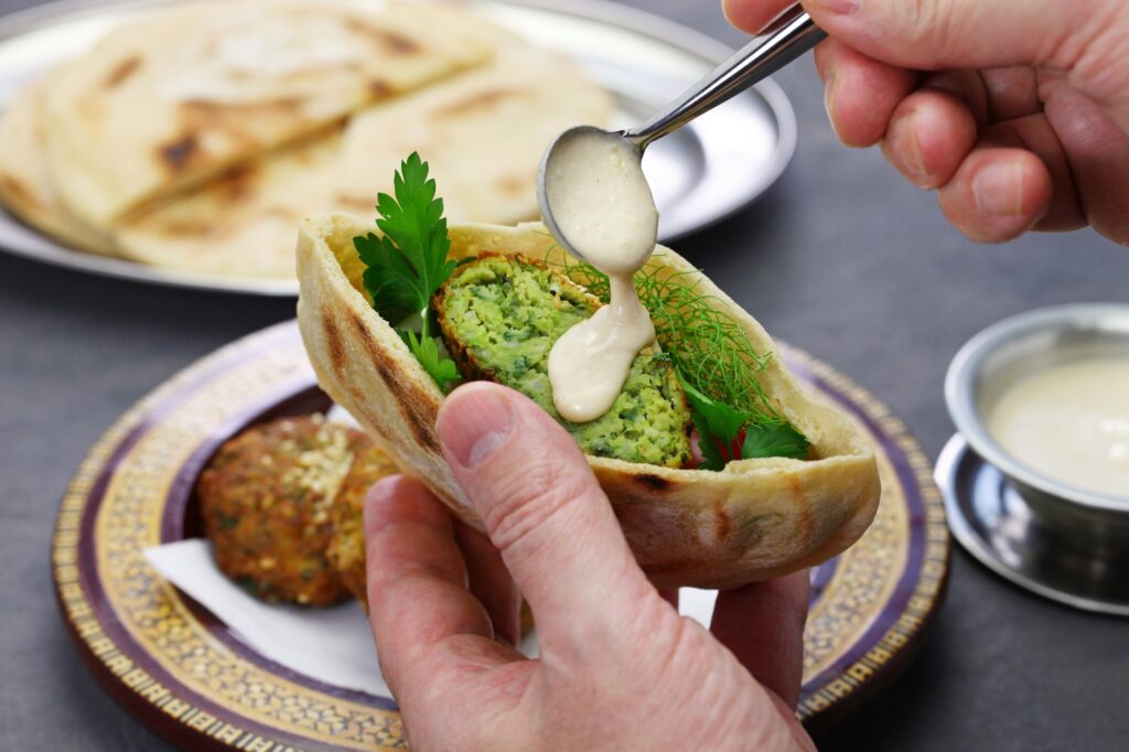 Food egyptian falafel served in a pita bread with tahini sauce