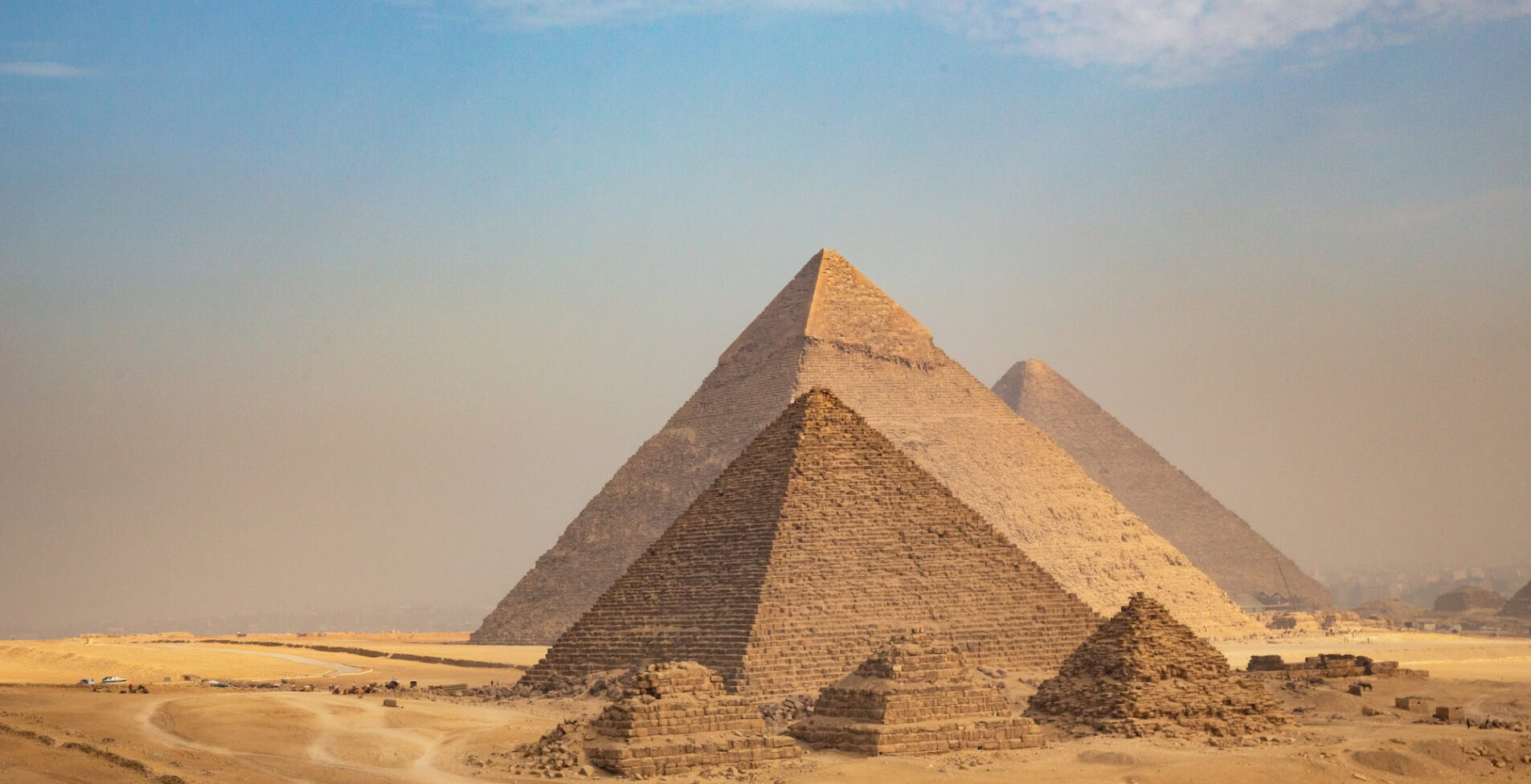 General view of pyramids from the Giza Plateau three pyramids known as Queens Pyramids on front side next in order from left the Pyramid of Menkaure Khafre and Chufu