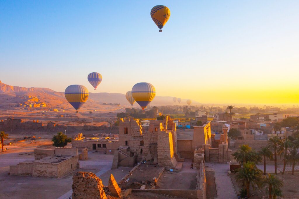 Hot air balloon above the Mortuary Temple of Ramesses III at Medinet Habu, Luxor – a breathtaking view on Egypt tours from Perth.