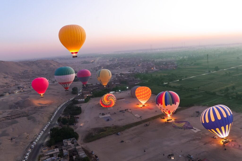 Hot air balloons drifting above the West Bank landscape during morning flights, Luxor