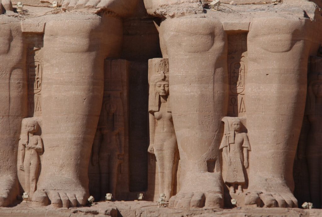 Massive statue legs of Ramses II in front of Abu Simbel