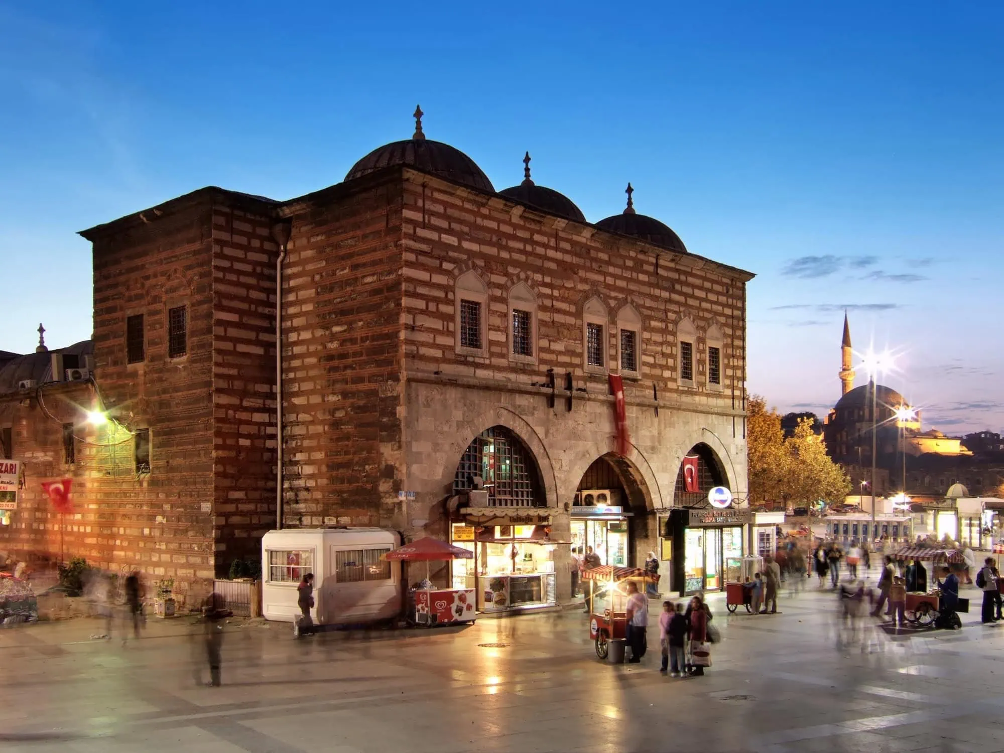 Historic Spice Bazaar building in Istanbul with Ottoman architecture illuminated at sunset