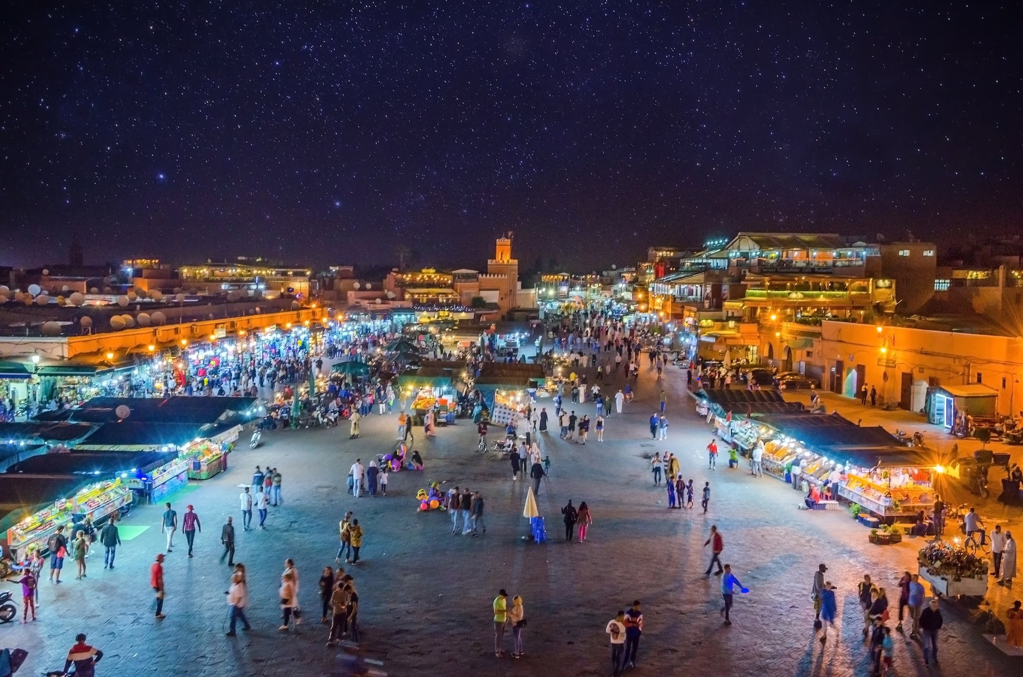 Djemaa el-Fna square at night with illuminated food stalls and bustling crowds