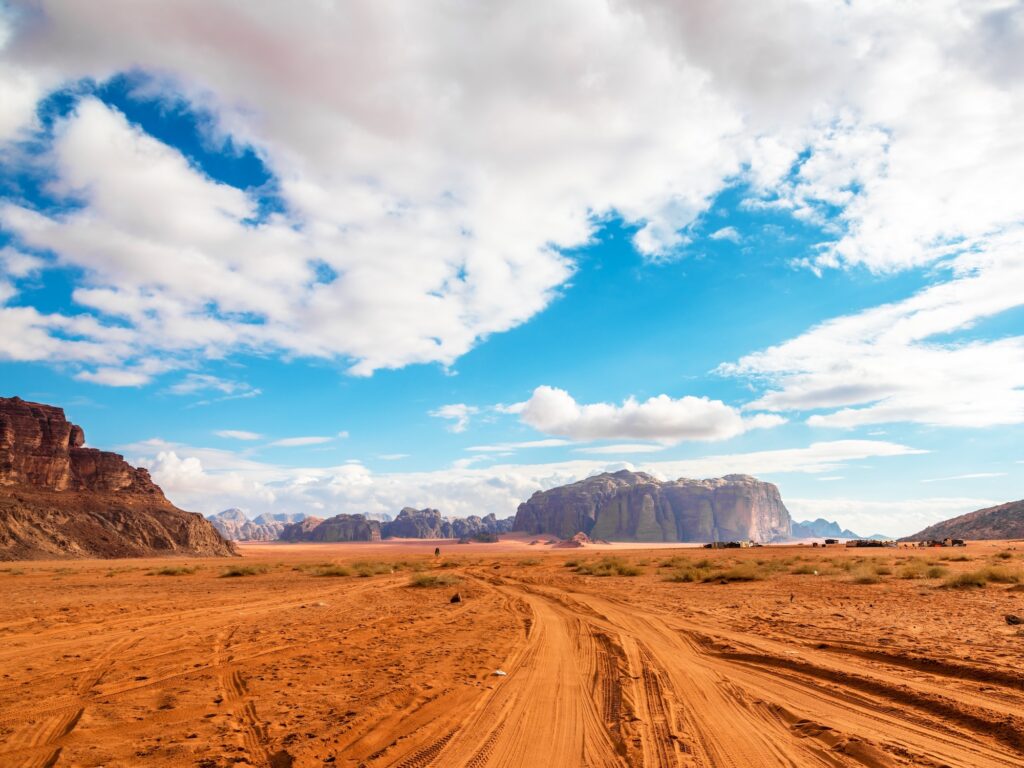 Sand dunes and sandstone mountains across the desert landscape of Wadi Rum, Wadi Rum