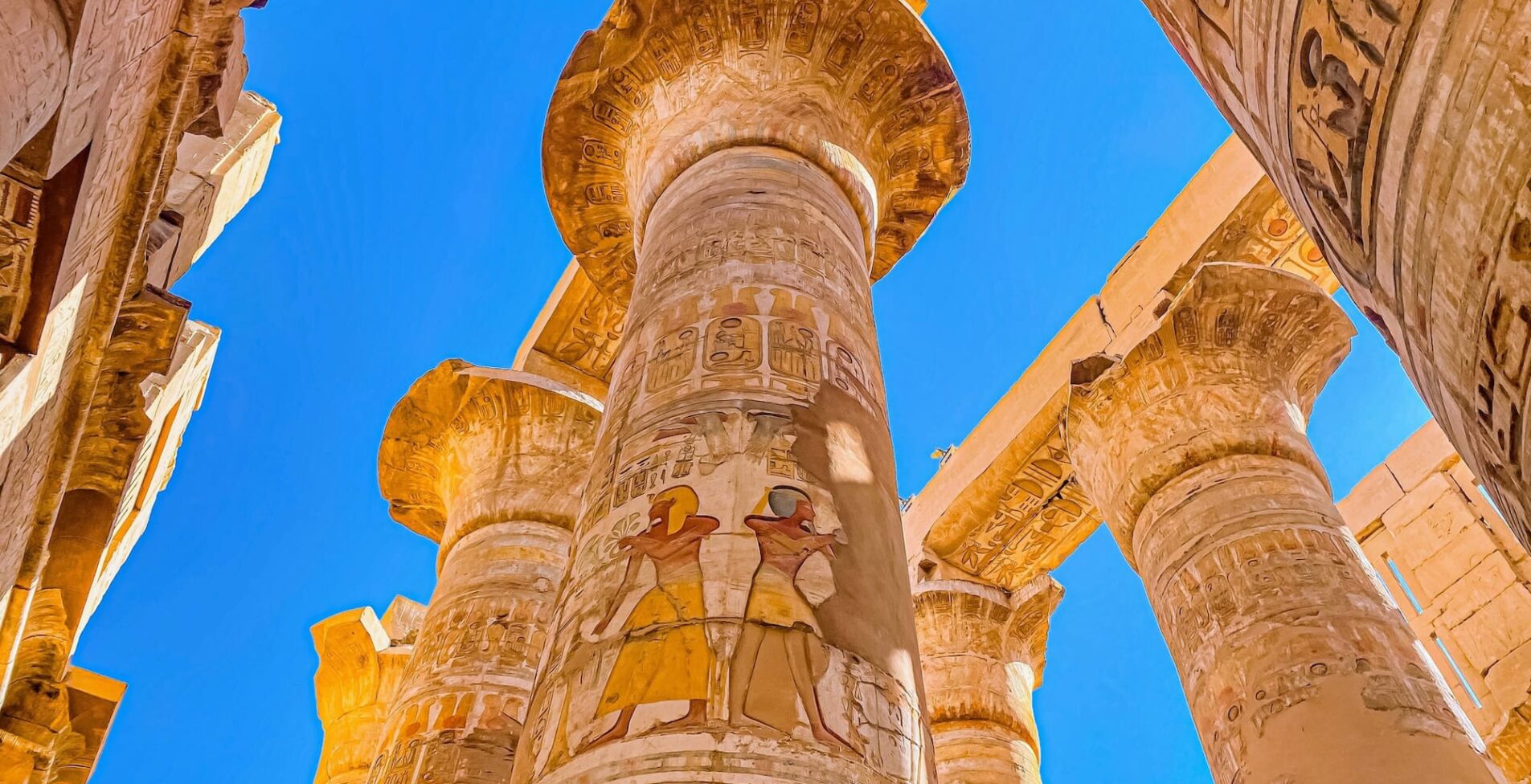 Karnak Temple is dedicated to the temple complex of Ancient Egypt in honor of the god Amun Ra his wife Mut and son Khons. Thebes Karnak Luxor Egypt 1 1905x976 crop 52 92