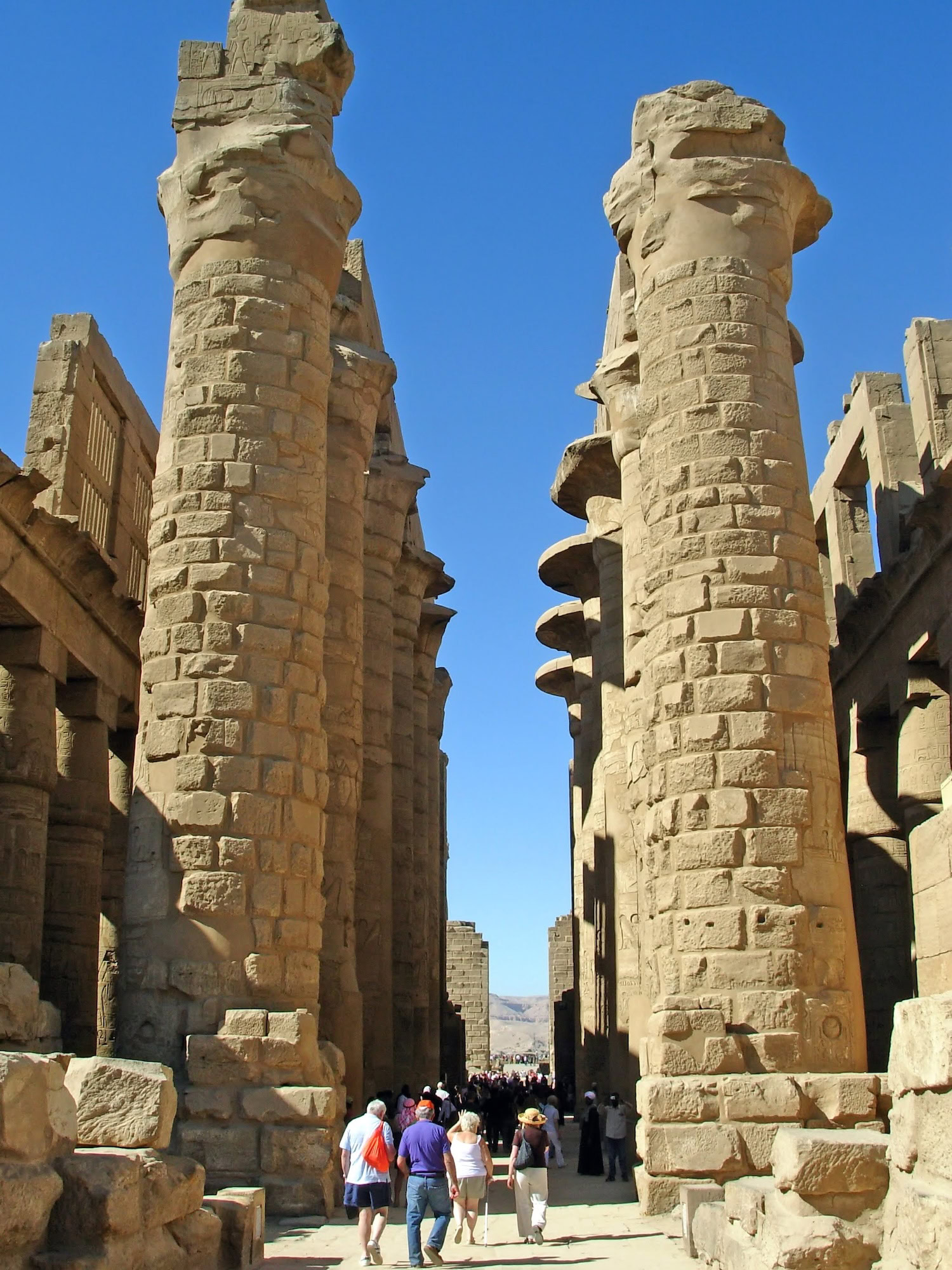 Tourists visiting ancient columns and ruins at Karnak Temple Complex in Luxor, Egypt
