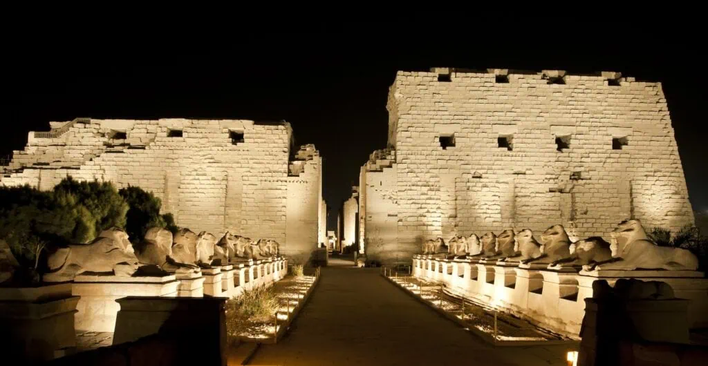 Illuminated entrance structures and stone walls at the Temple of Karnak during the Sound and Light show, Luxor