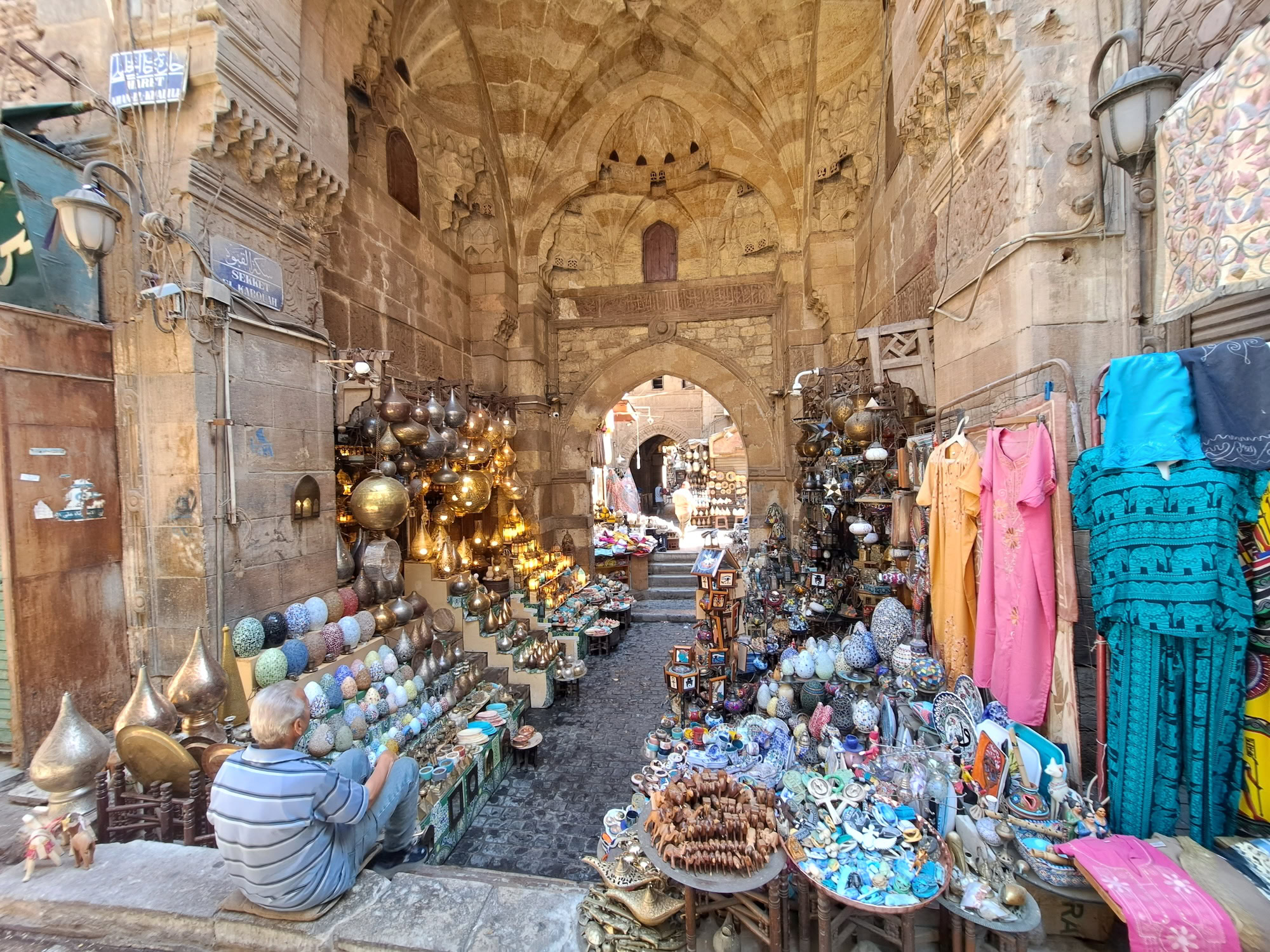 Khan el-Khalili bazaar stalls displaying traditional Egyptian crafts, pottery, and decorative souvenirs