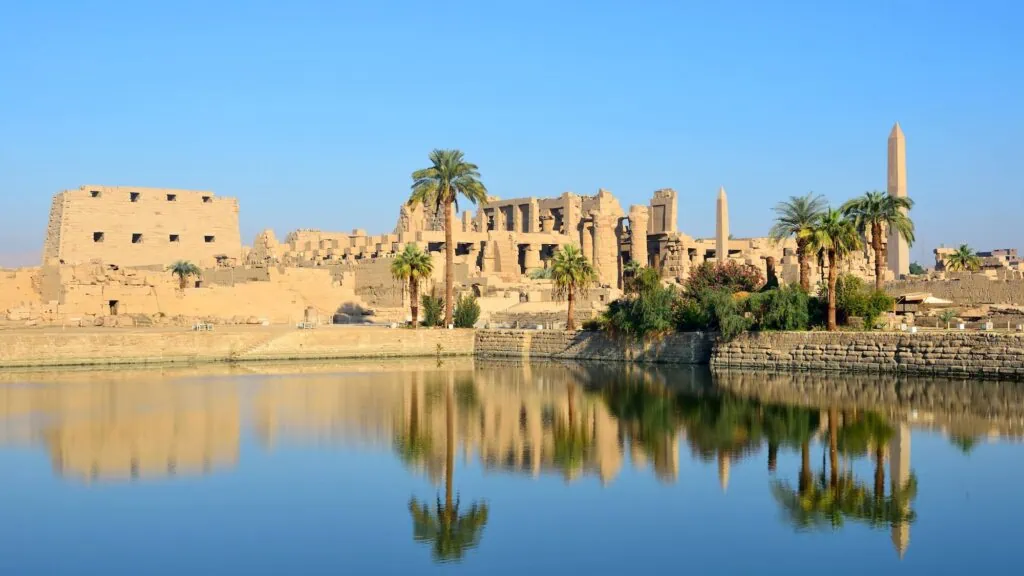 Sacred Lake within the Karnak Temple complex showing a rectangular water basin surrounded by stone embankments, Luxor