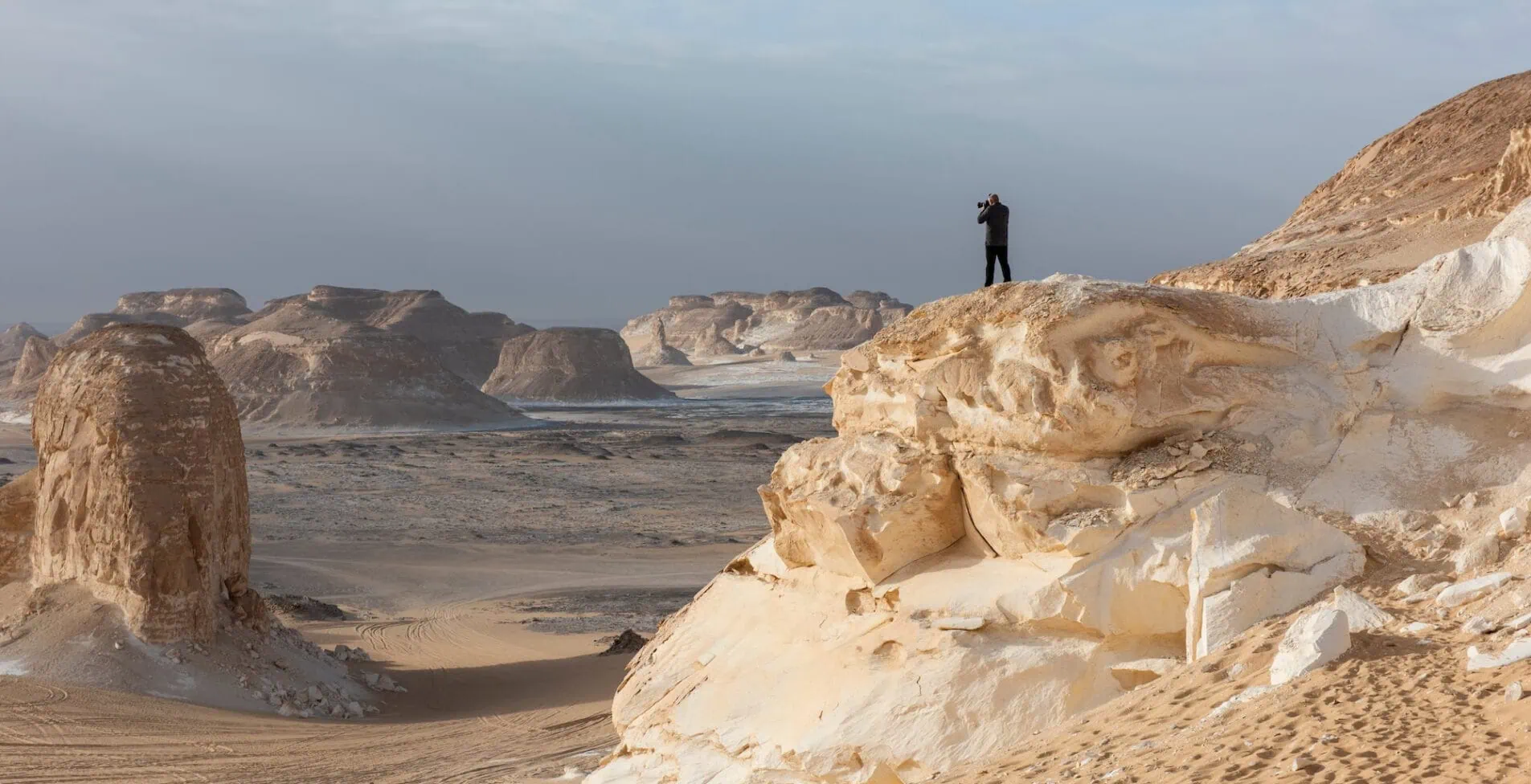 Landscape scenic view of desolate barren western desert in Egypt Valley of Agabat Obstacles at Farafra Oasis with geological rock formations 1905x976 crop 51 39