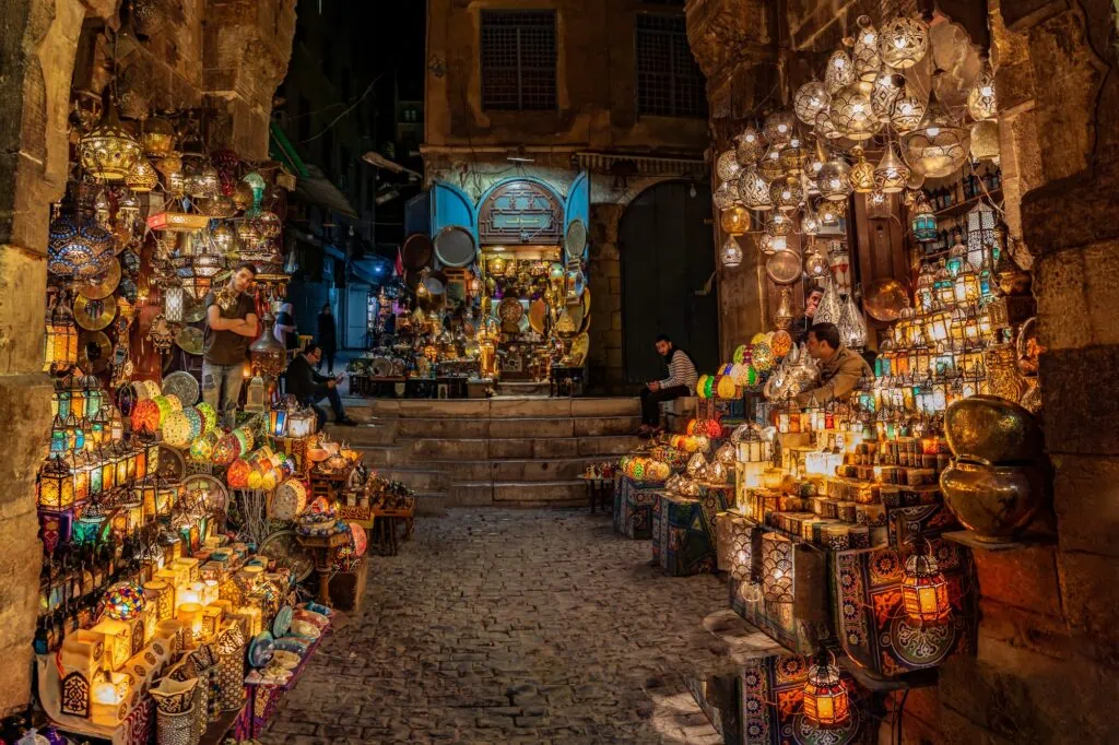 A shop selling colourful traditional Egyptian fanous lanterns, lit up at night in the Khan El Khalili bazaar in Islamic Cairo, Egypt.