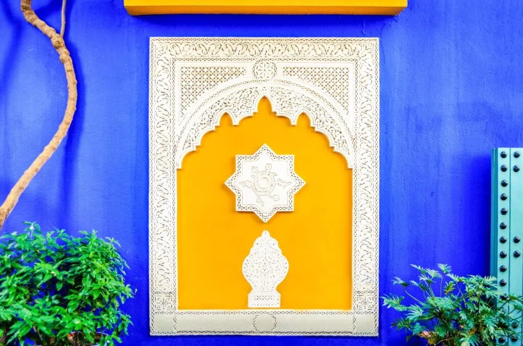 Colorful window in Jardin Majorelle, former residence of fashion designer Yves Saint Laurent in Marrakesh Morocco. Yellow window frames of the blue house of Yves Saint-Laurent. Museum of Islamic art.