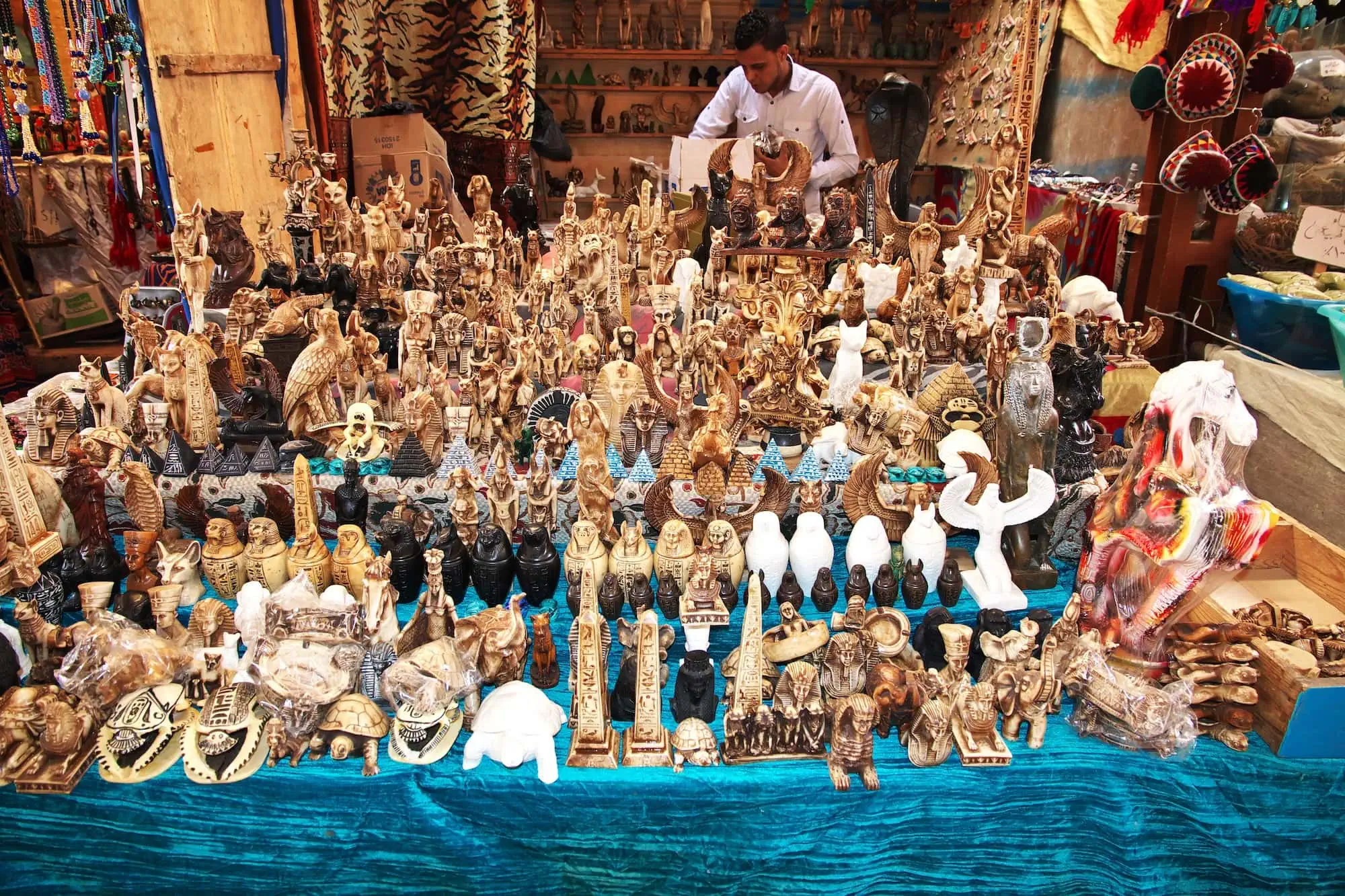 Bustling Egyptian souvenir market with pharaoh figurines and traditional handicrafts