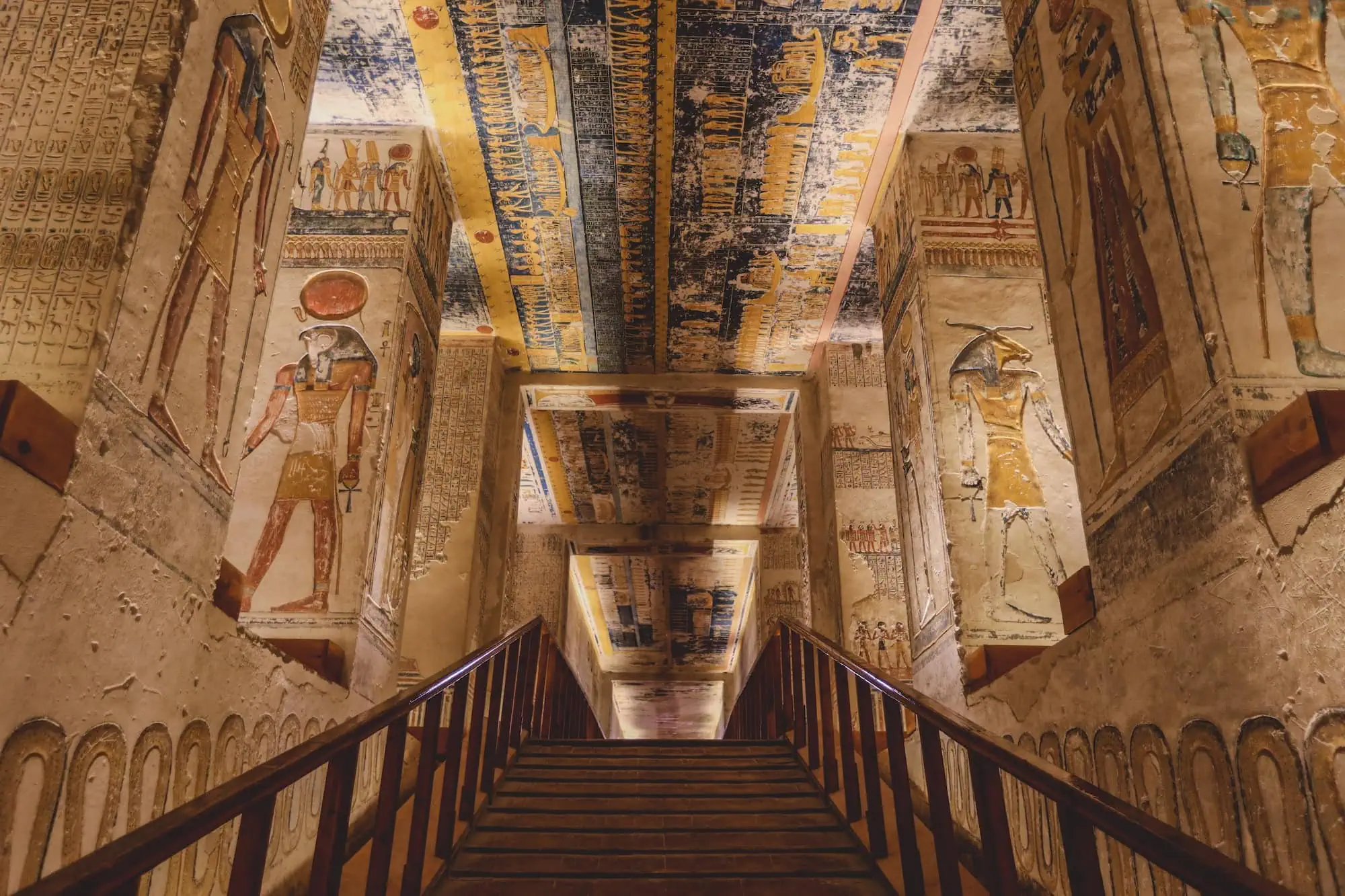 Interior view of ancient Egyptian pharaoh tomb with colorful hieroglyphic wall paintings and burial chamber