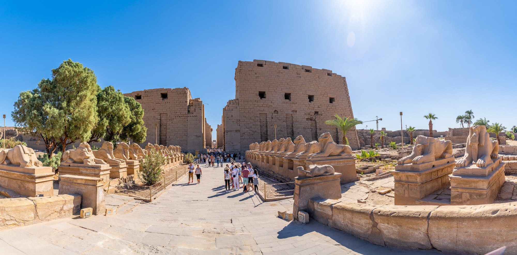 Ancient Karnak Temple complex with sphinx-lined ceremonial pathway in Egypt