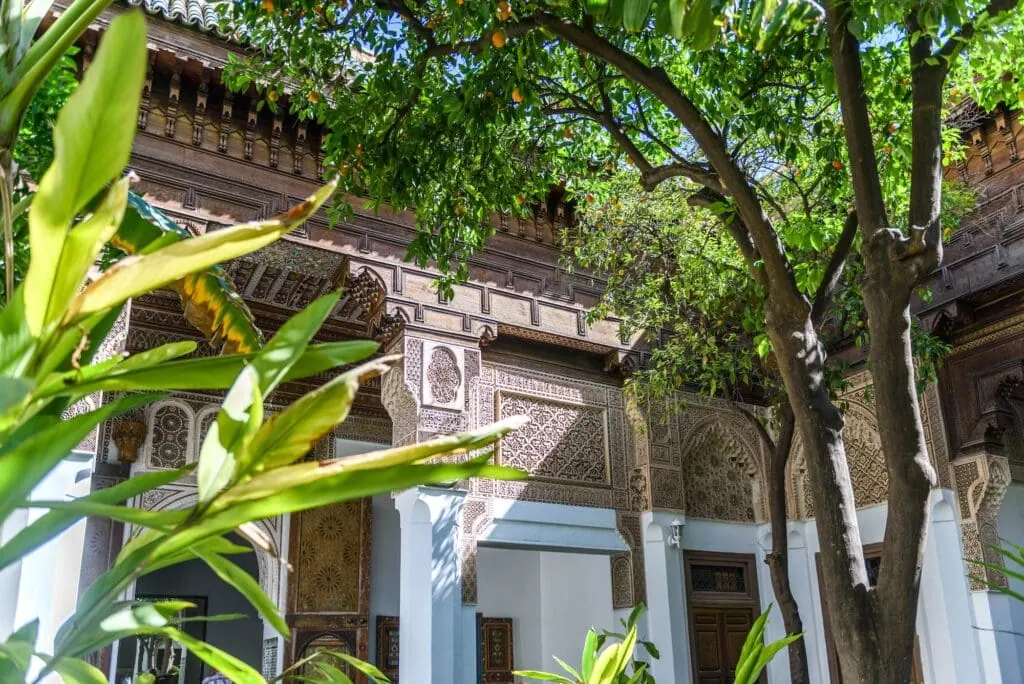 Dar Si Said Museum interior garden with tiled courtyard, carved stucco walls, and surrounding wooden gallery Marrakech