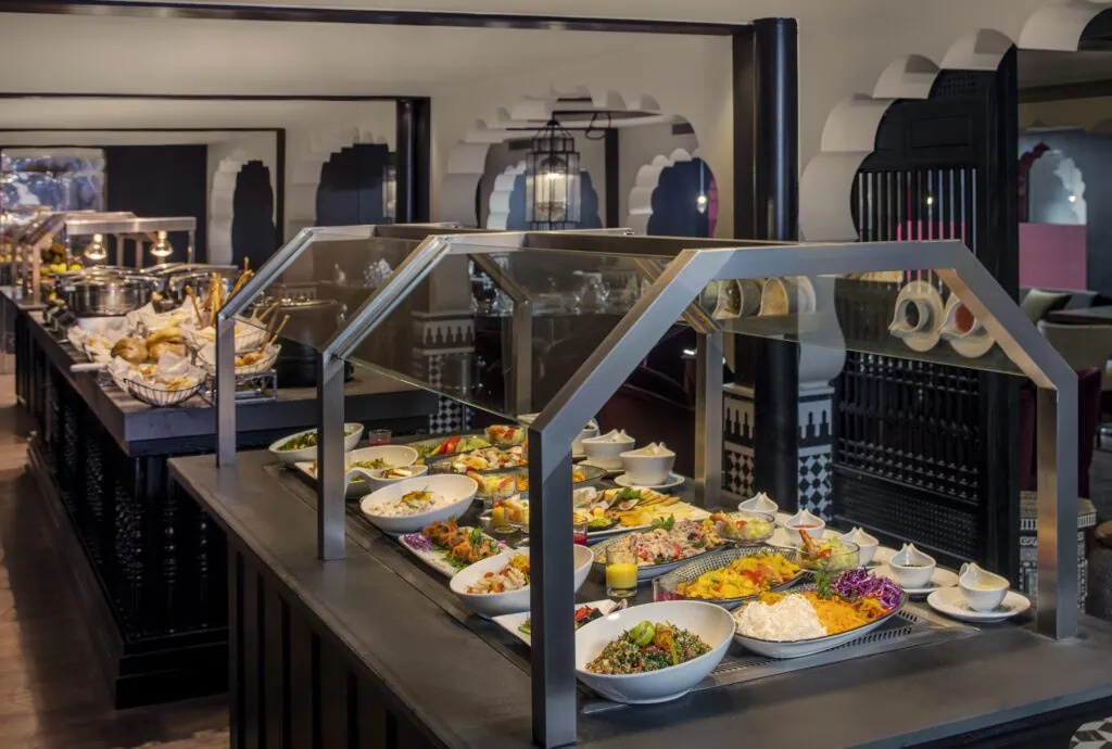 The morning buffet aboard the Mövenpick MS Darakum, with a varied spread of breakfast dishes including fresh fruit, bread, hot dishes, and beverages laid out on serving tables.