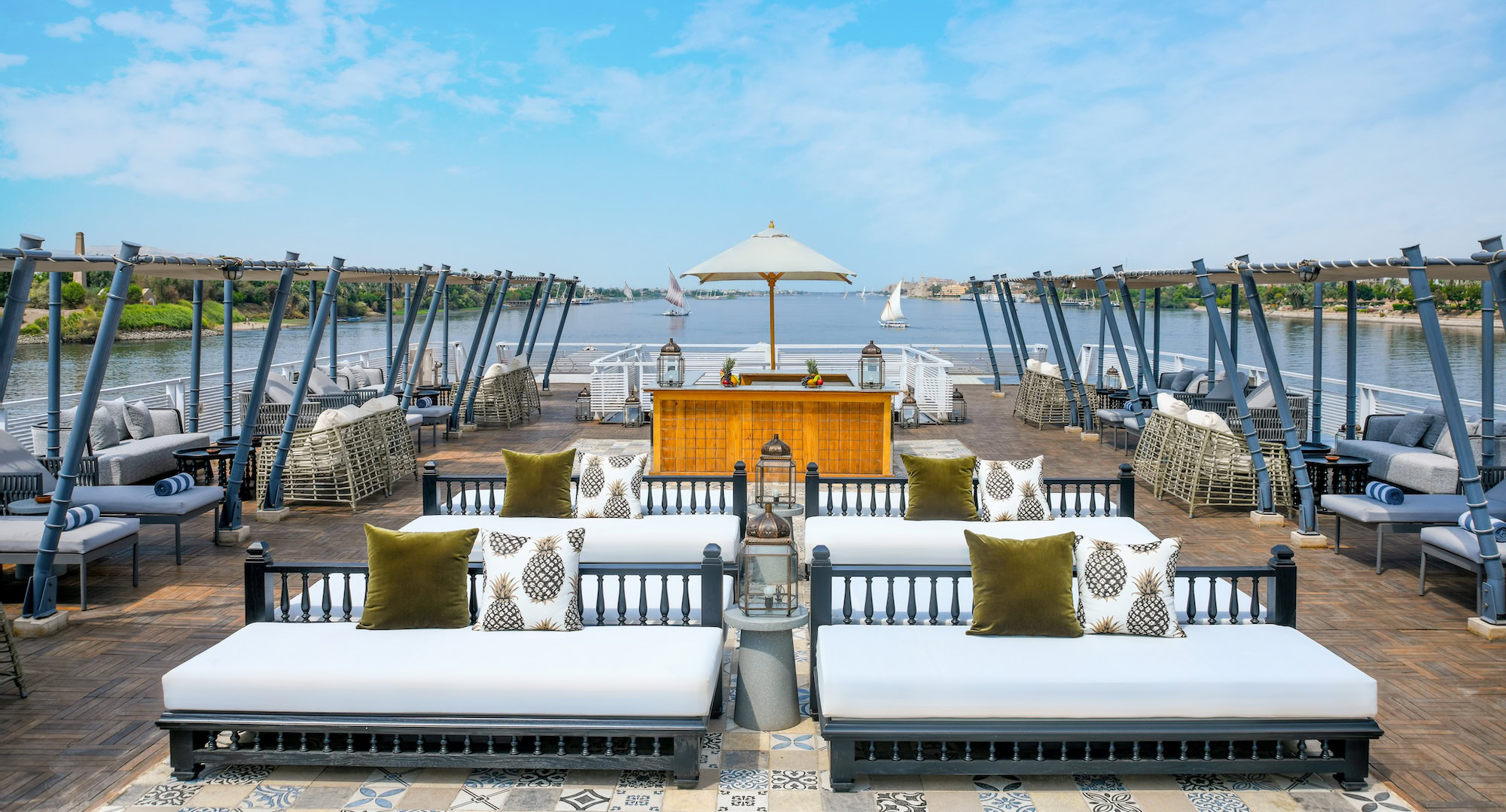 Luxury Nile River cruise ship deck with comfortable lounge chairs and elegant furnishings