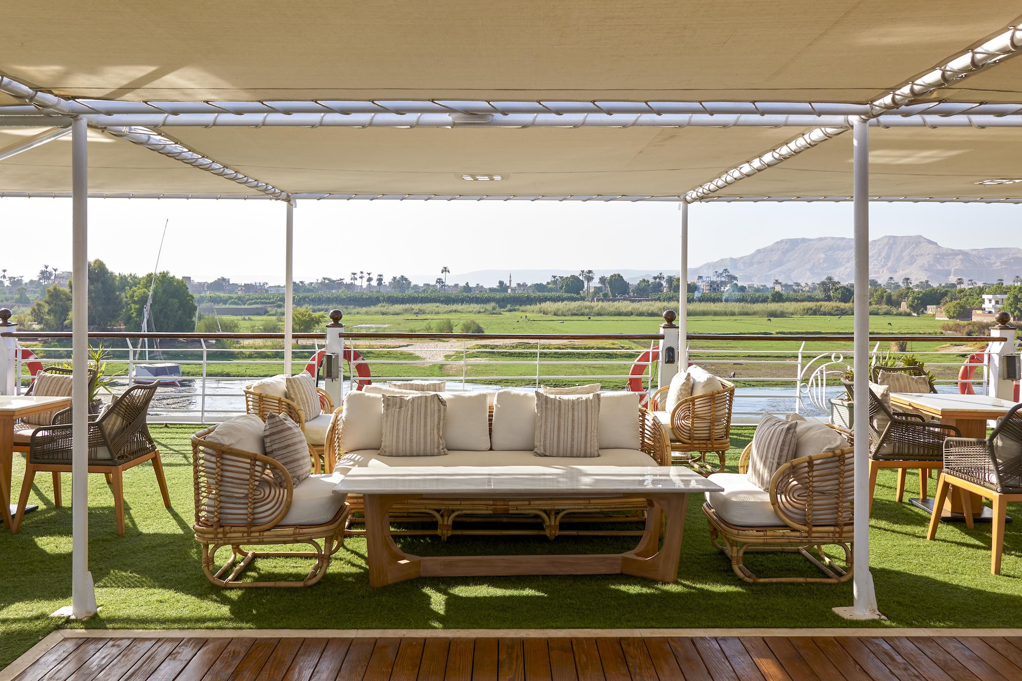 Luxury Nile River cruise boat with comfortable outdoor seating and scenic river views