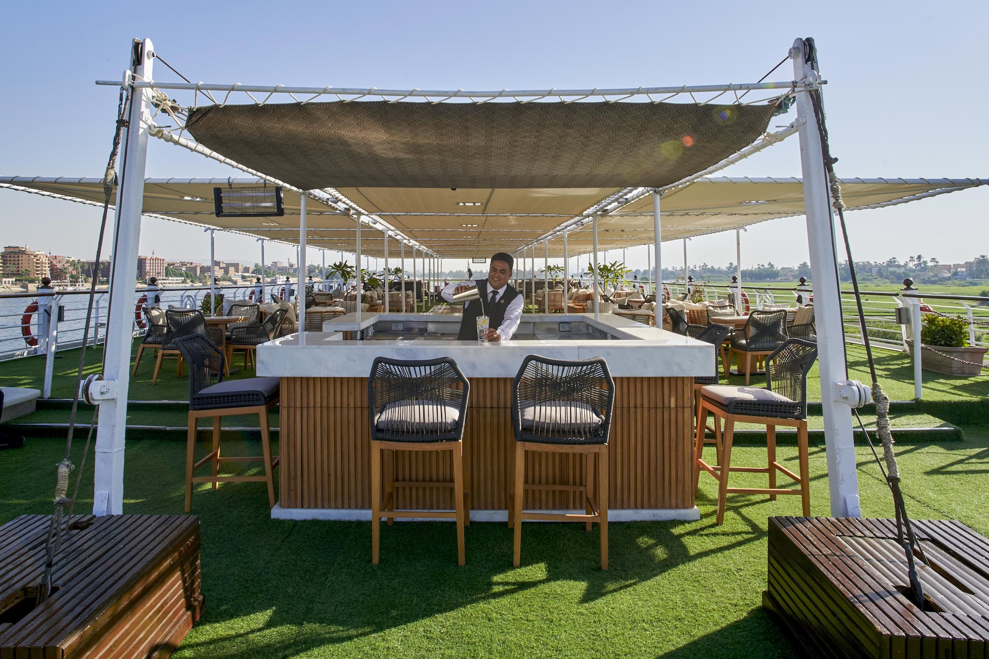 Luxury Nile cruise ship deck with outdoor bar and dining facilities