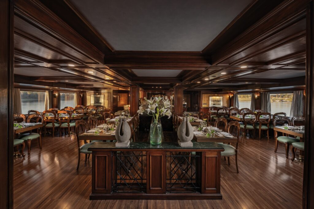 Main buffet restaurant aboard the MS Salacia, a 5-star Luxury Nile Cruise vessel sailing the Luxor–Aswan stretch, with panoramic windows opening onto the Nile, serving full-board breakfast, lunch, and dinner with international and Egyptian dishes.