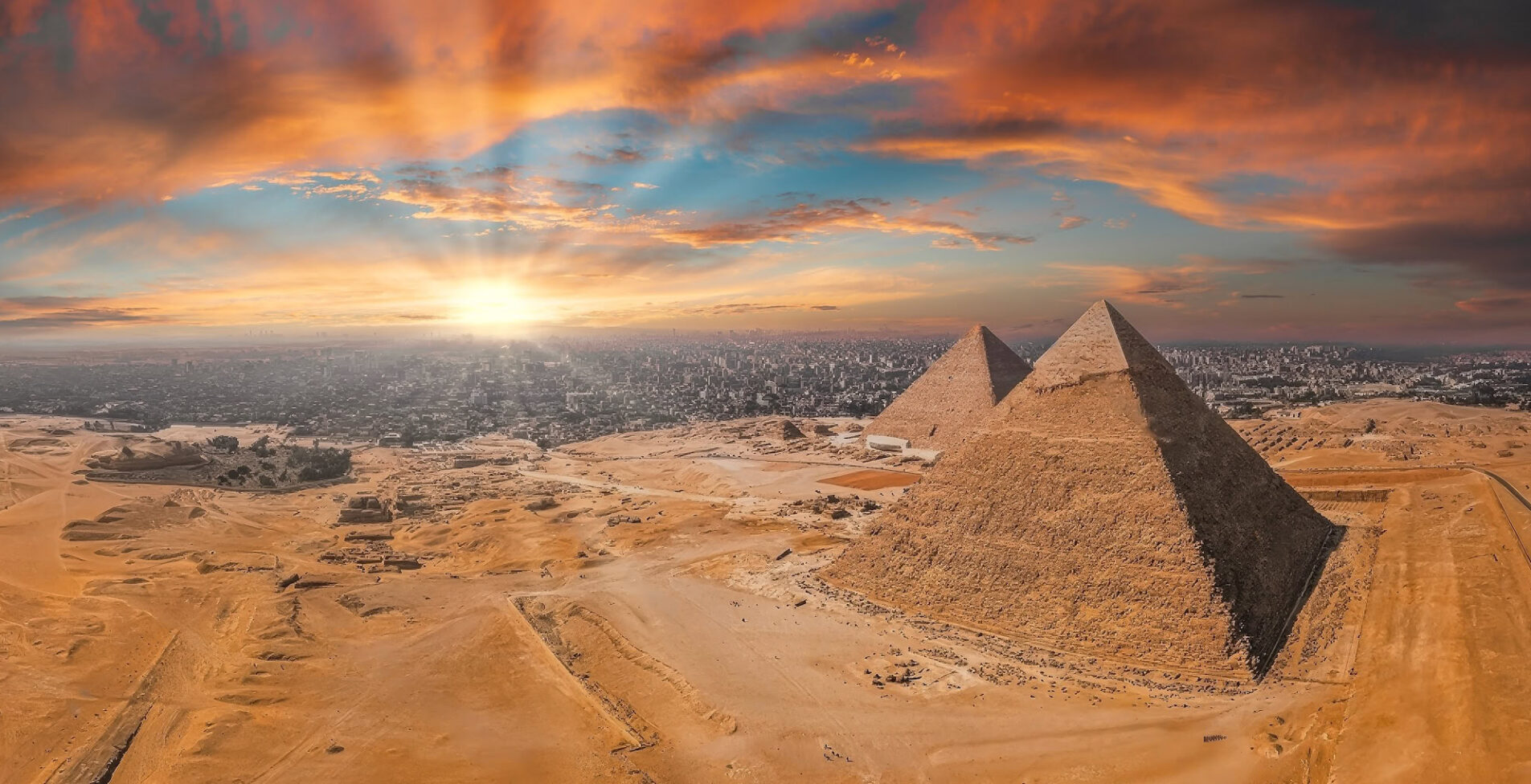 Magical sunset over the Egyptian pyramids. Aerial view of the Pyramids of Giza in Egypt 1905x976 crop 48 75