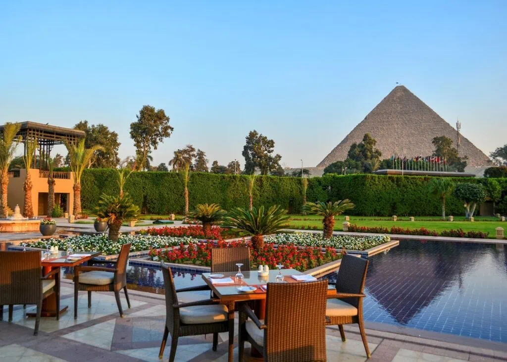 View of the Pyramids of Giza from the gardens of Marriott Mena House hotel in Giza, Egypt — historic 19th-century property with direct pyramid views from the gardens and select rooms