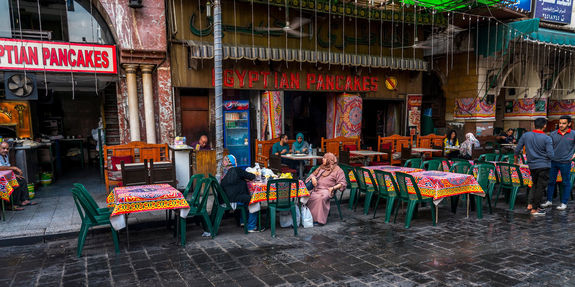 Egyptian pancakes restaurant with traditional dining setup and bustling atmosphere
