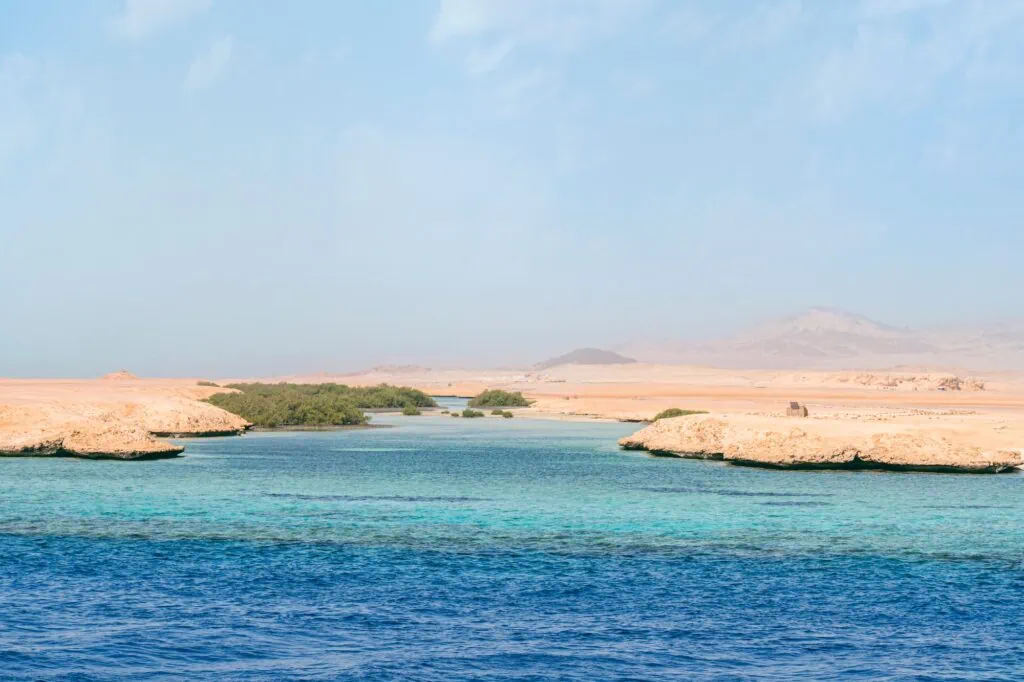 Sea view of sandy shoreline with desert landscape and blue sky at Ras Mohammed National Park, Sharm El Sheikh