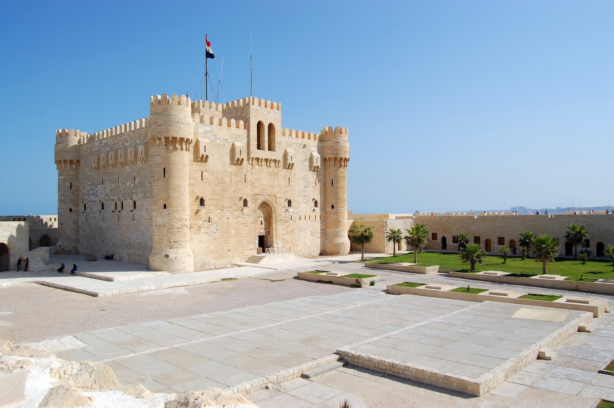 Ancient stone blocks and fortress walls inside the Citadel of Qaitbay courtyard