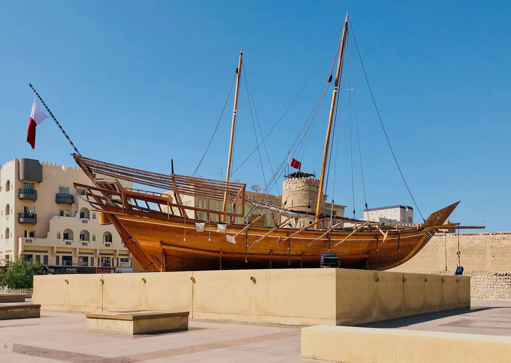 Traditional wooden dhow boat exhibit at Dubai Museum entrance with Al Fahidi Fort architecture