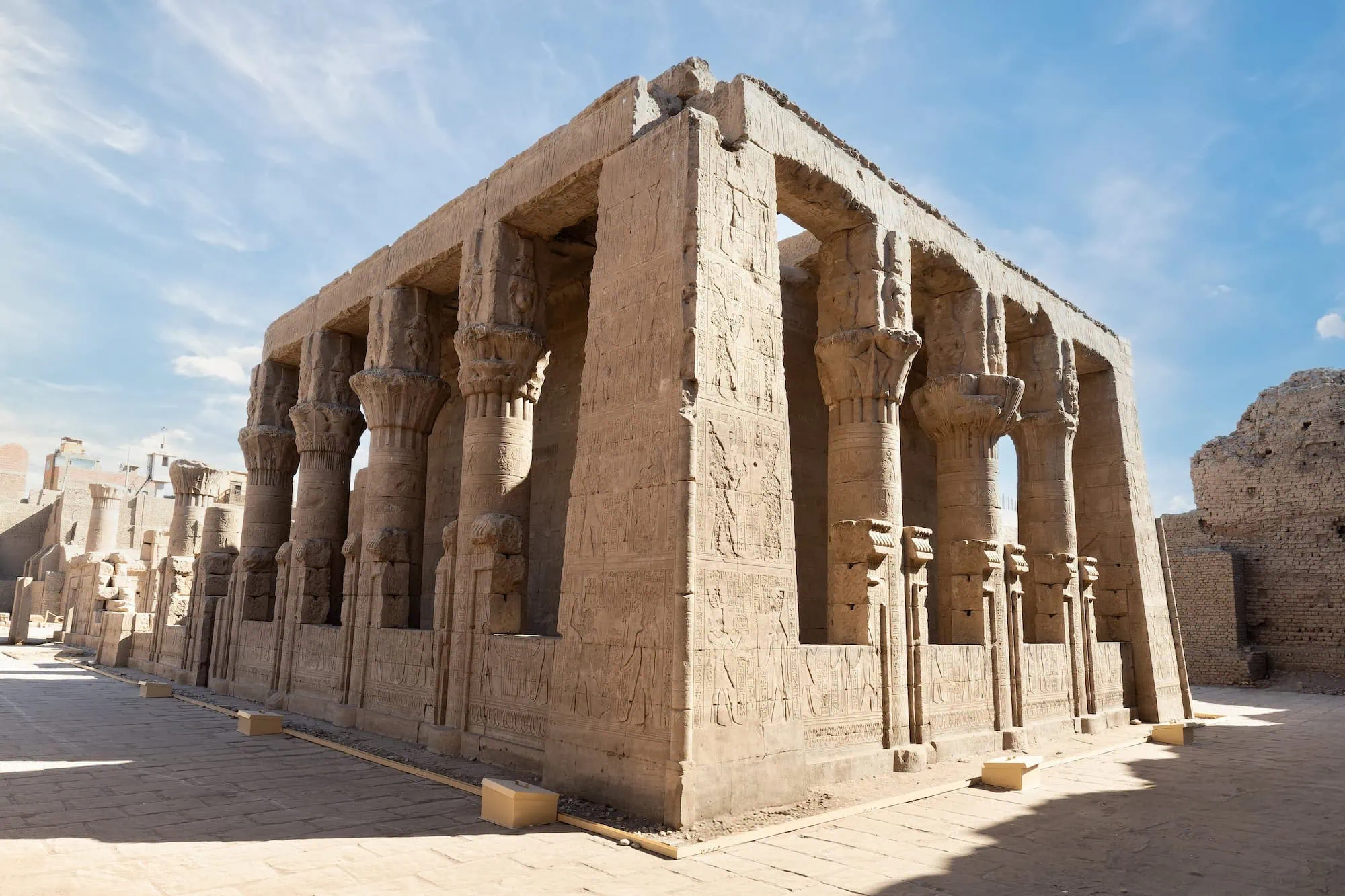 Ancient Temple of Edfu showing preserved stone columns with hieroglyphs and carved reliefs