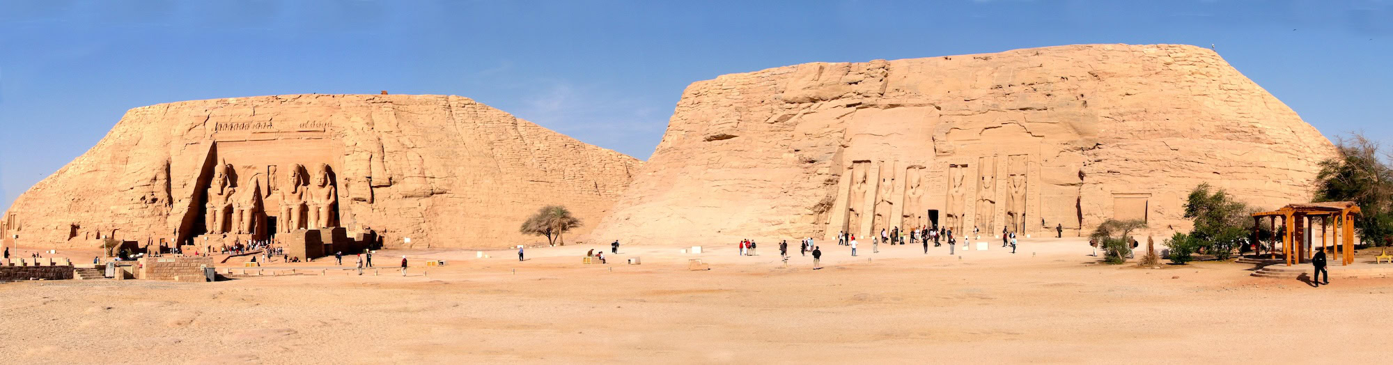 Abu Simbel temples with tourists visiting the ancient Egyptian monuments in the desert
