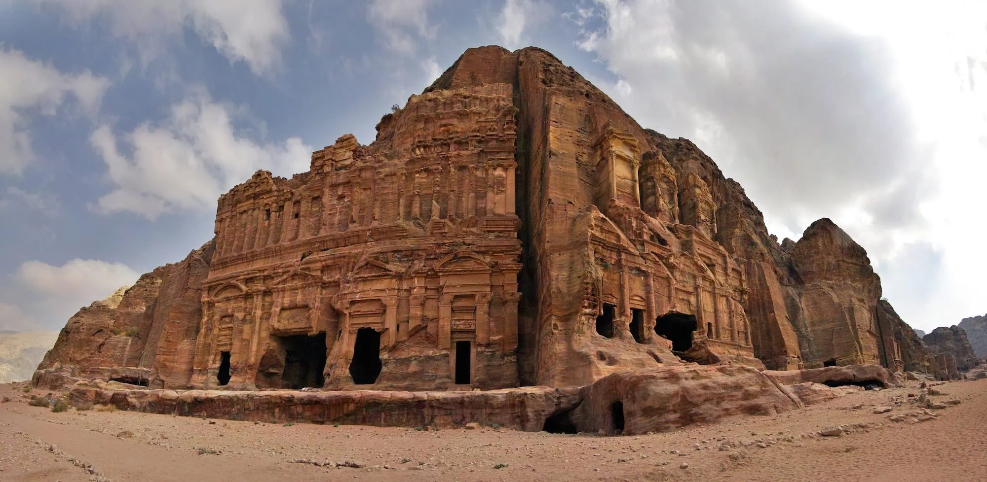 Ancient Nabataean Royal Tombs carved into rose-colored sandstone cliffs at Petra