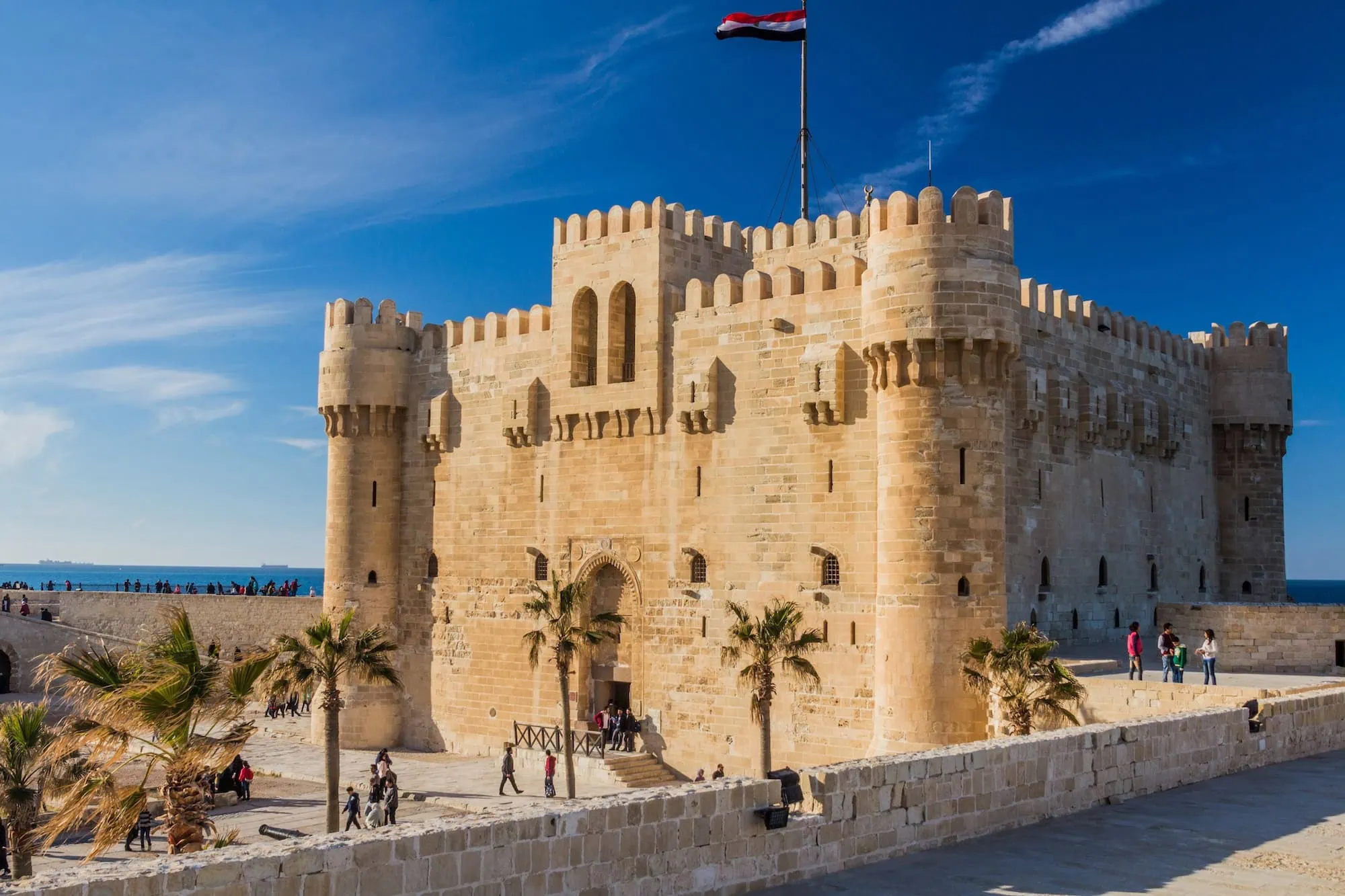 Tourists visiting the historic Citadel of Qaitbay fortress in Alexandria on a sunny day