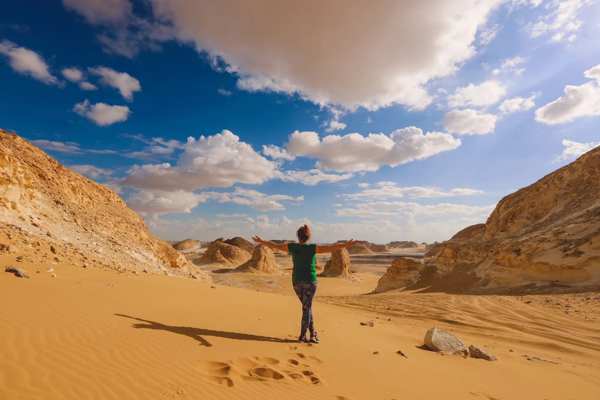 Person walking through White Desert landscape in Western Desert, Egypt