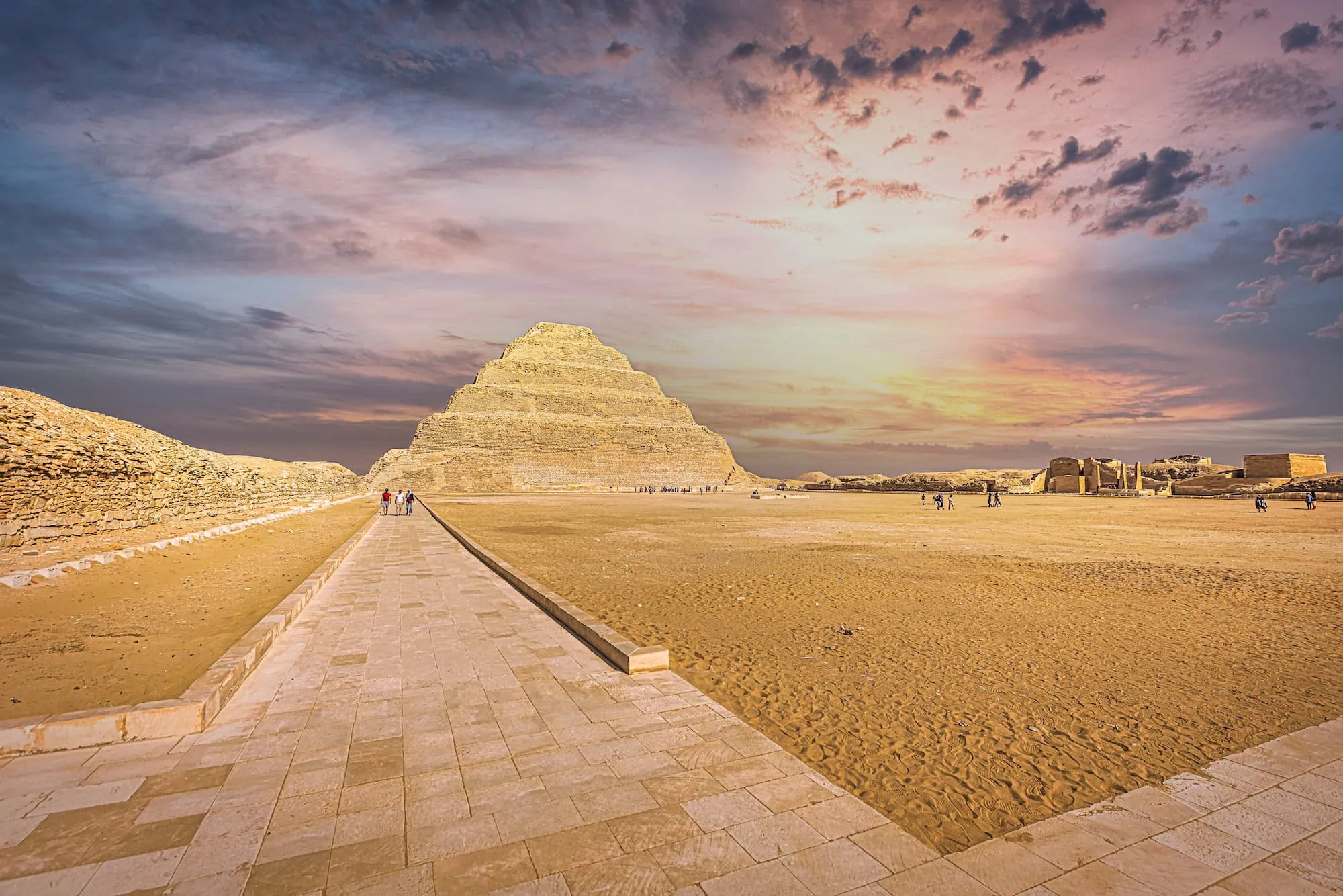 Majestic Step Pyramid of Djoser at Saqqara necropolis with stone walkway and desert landscape