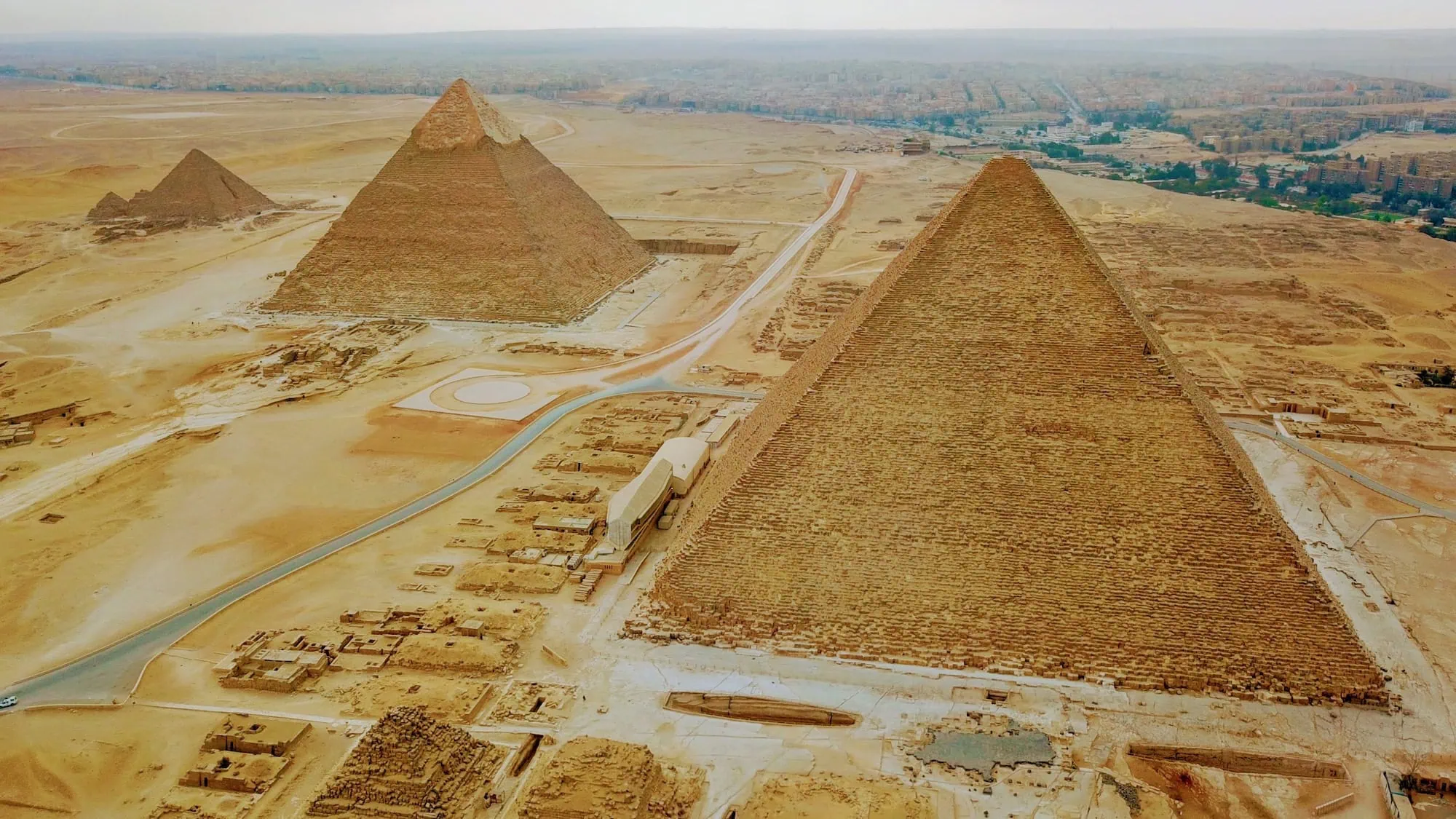 Aerial view of the Great Pyramids of Giza complex with sphinx and tourist pathways